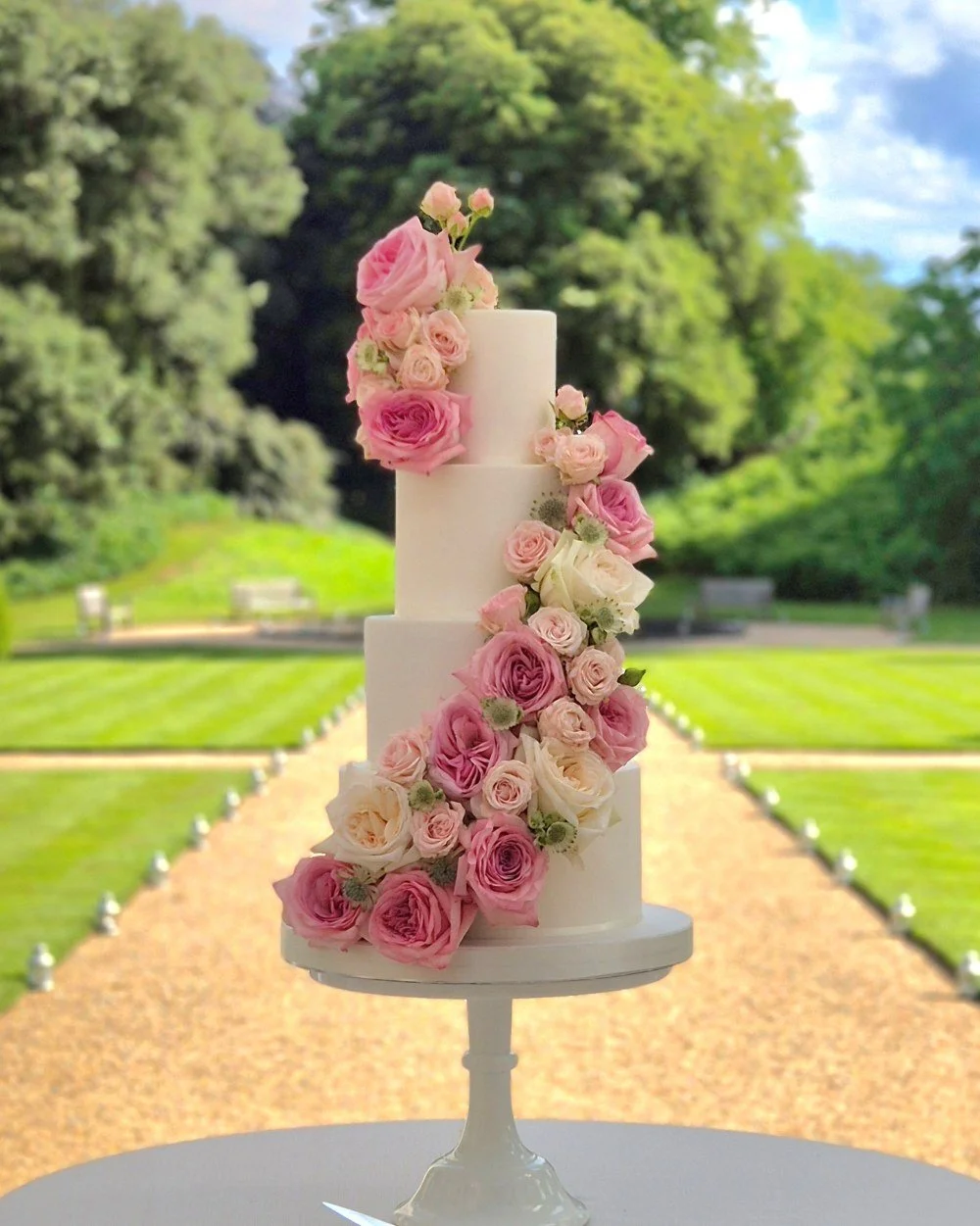 classic wedding cake with a cascade of fresh flowers pink roses
