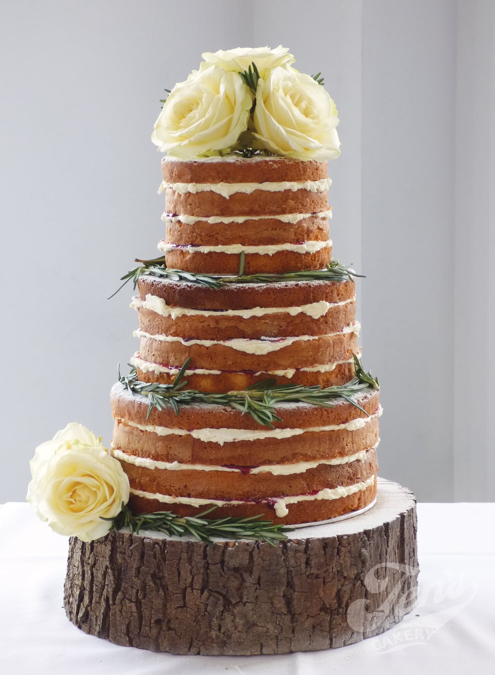  This naked cake looks beautiful with just sprigs of rosemary and fresh roses. 