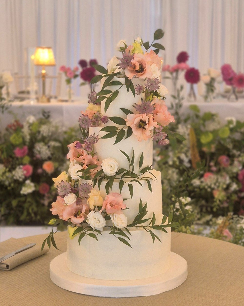 buttercream covered wedding cake with fresh flowers