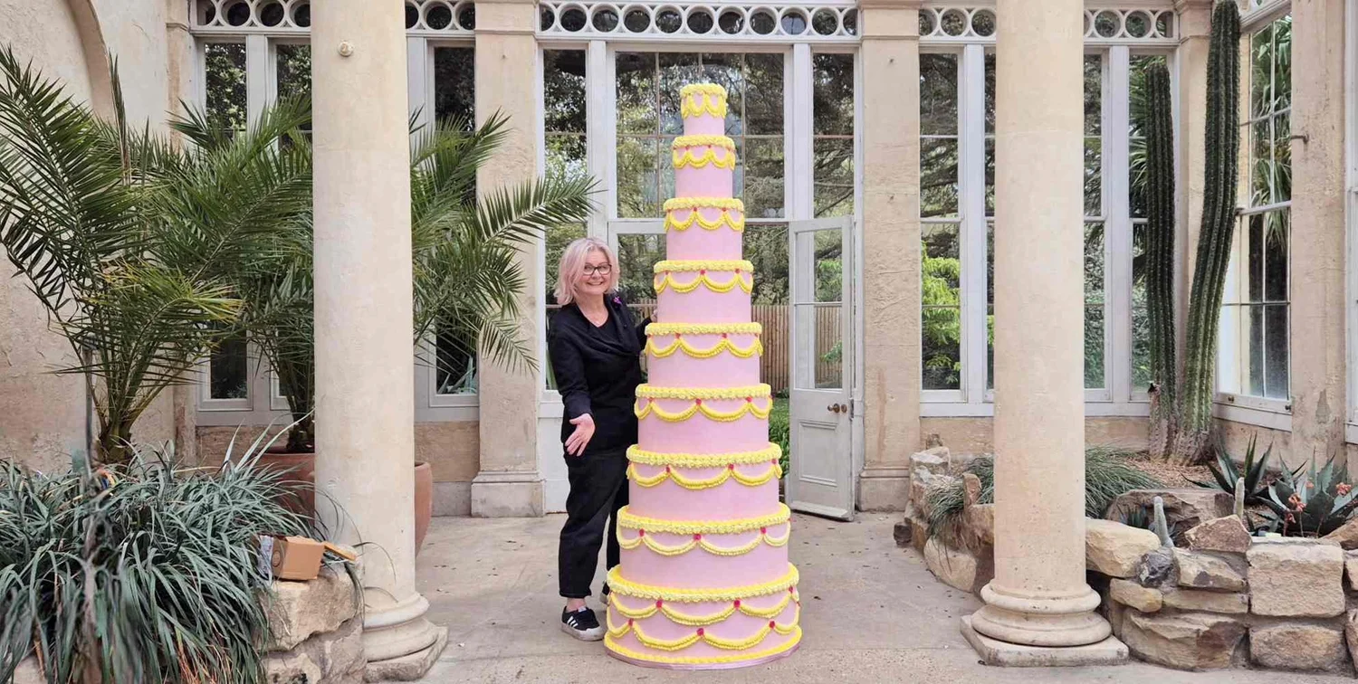 Jen with a tall wedding cake at Syon House in West London