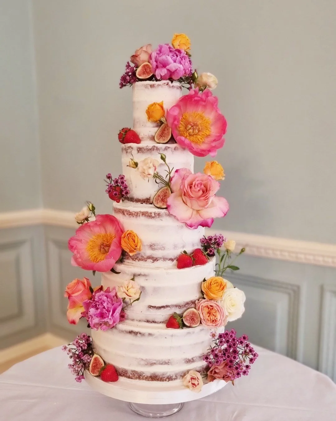 semi naked wedding cake with peonies and fresh fruit