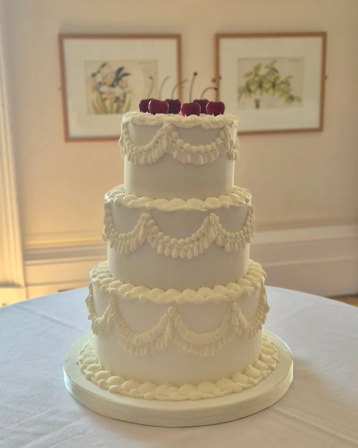  3 tier white wedding cake with white lambeth piping and raspberries 