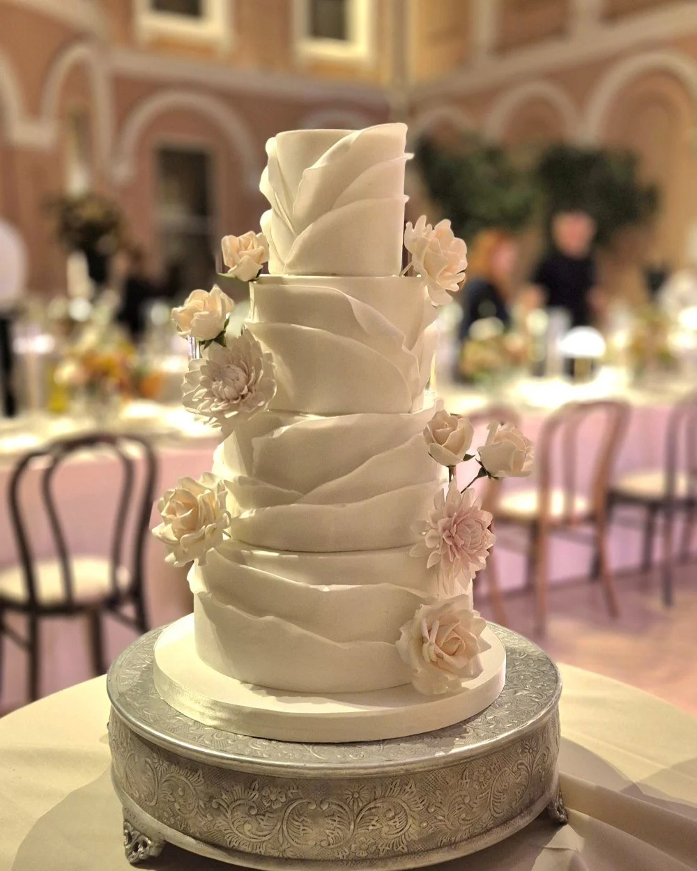 striking modern wedding cake with wrapped icing and sugar flowers at the Wallis Collection