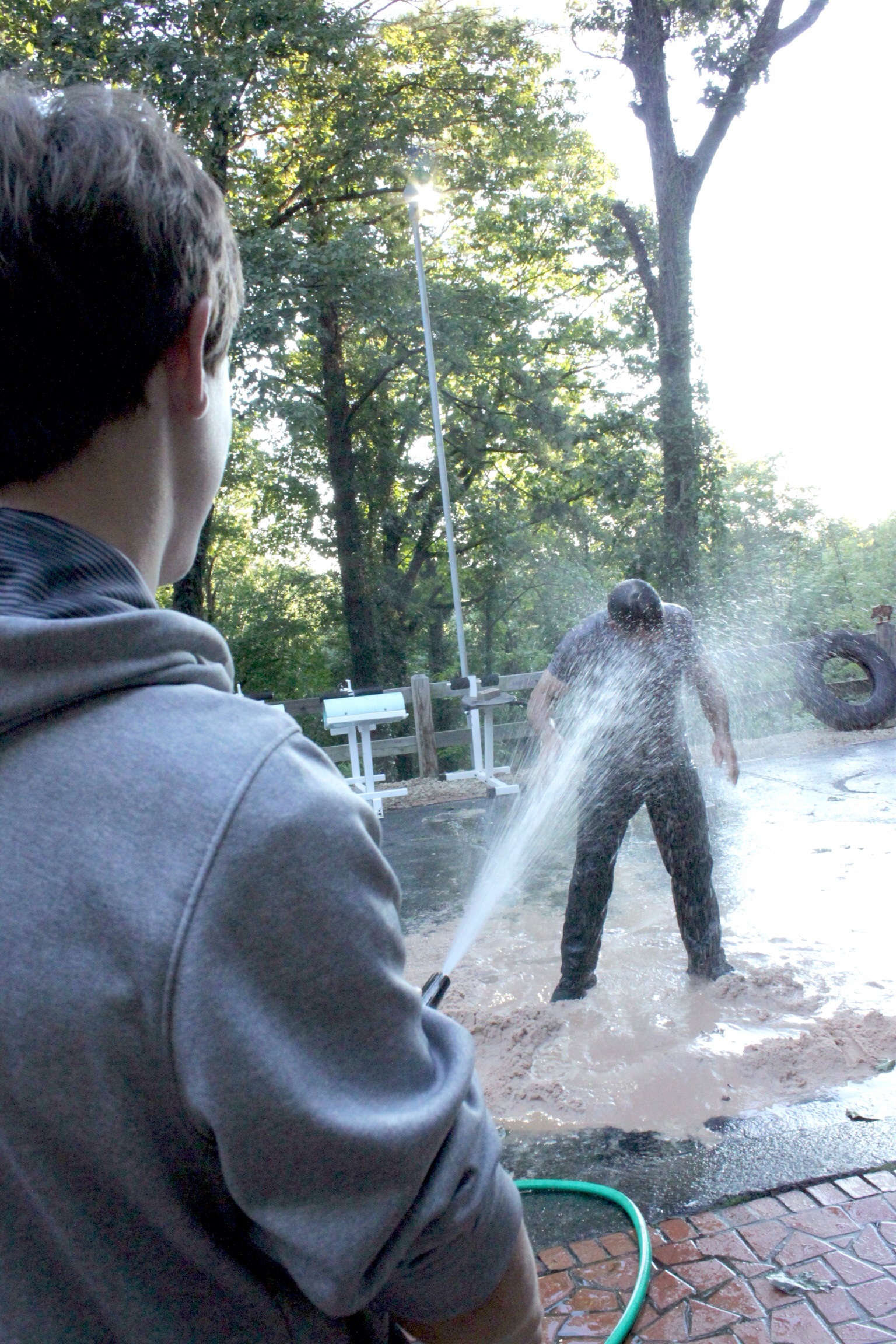 Hayden hits me with a hose during the 1000 burpee/5 mile Run-Burpee-Run workout