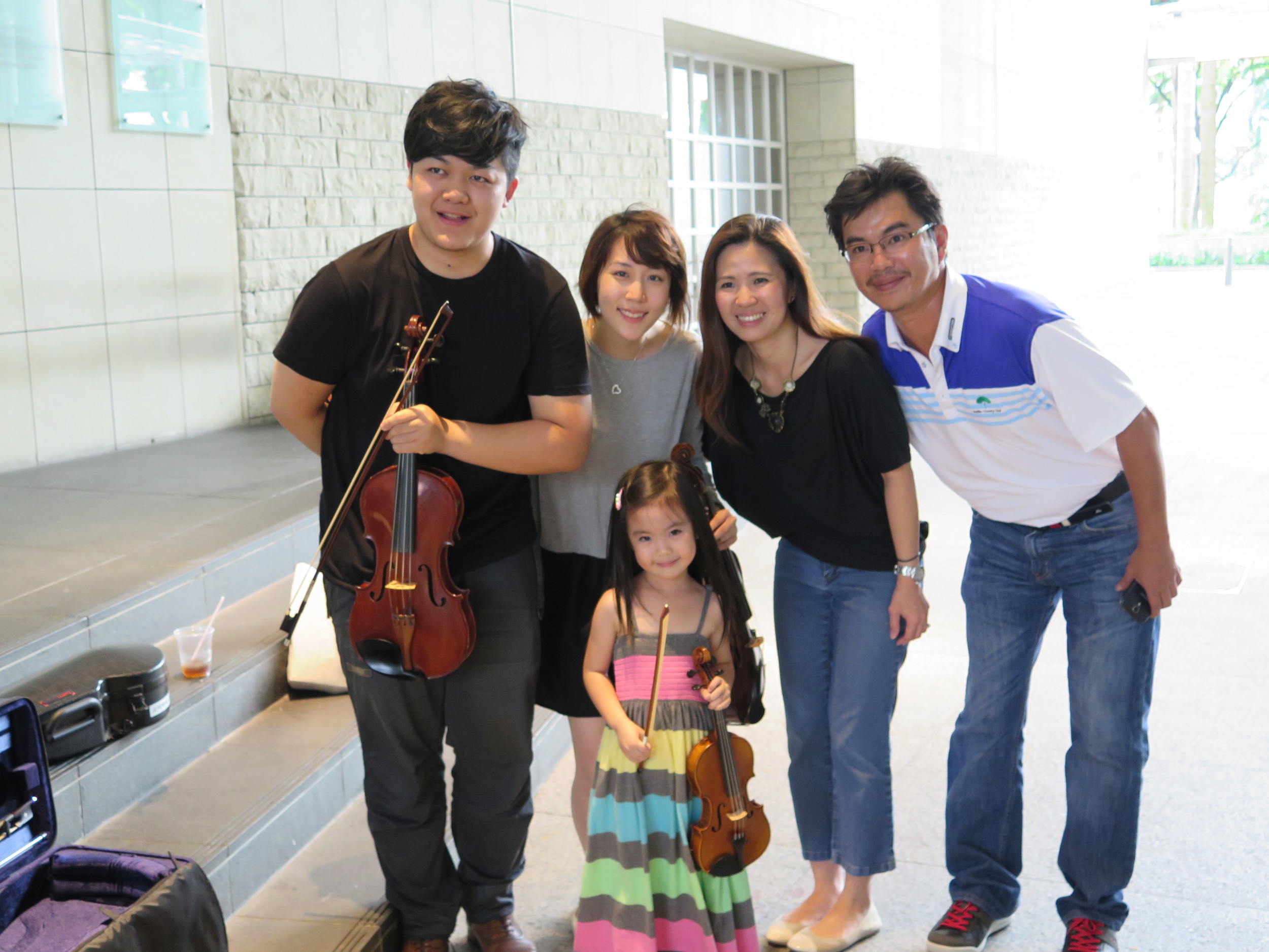 Young Ellie with her proud parents, Mr and Mrs Layson as well as teacher Tingxi and teacher Jeremiah