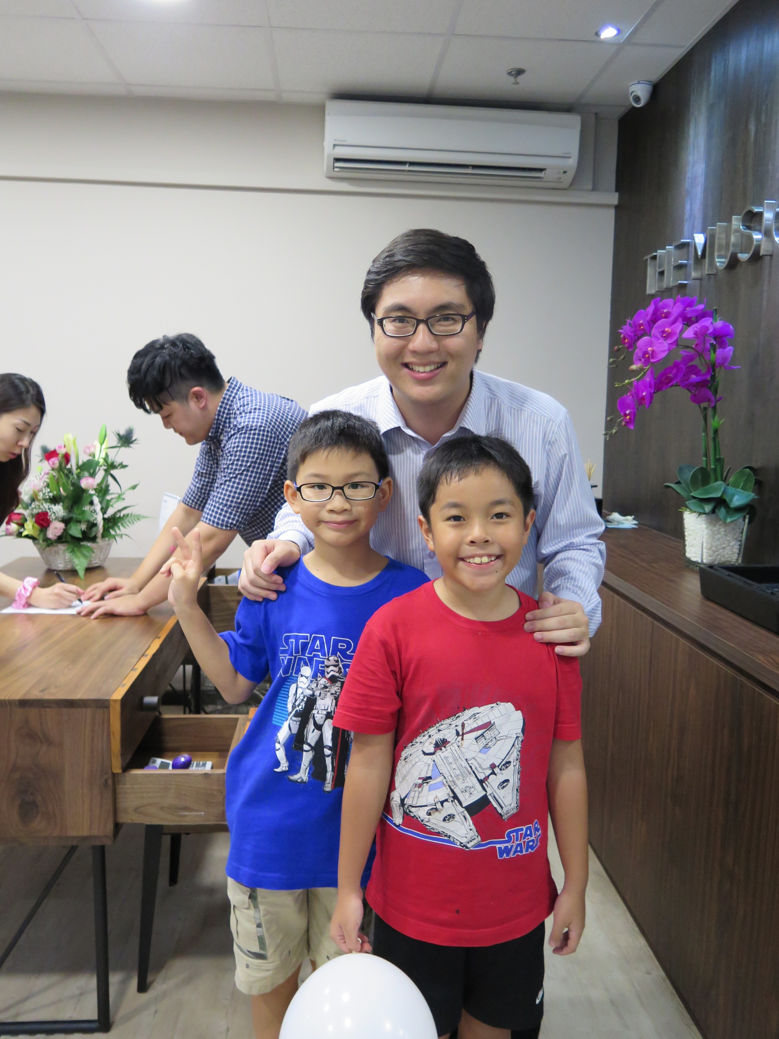 Teacher Wei Yang with his students Matthew and Samuel. Teacher Jeremiah pictured in the background busy as usual