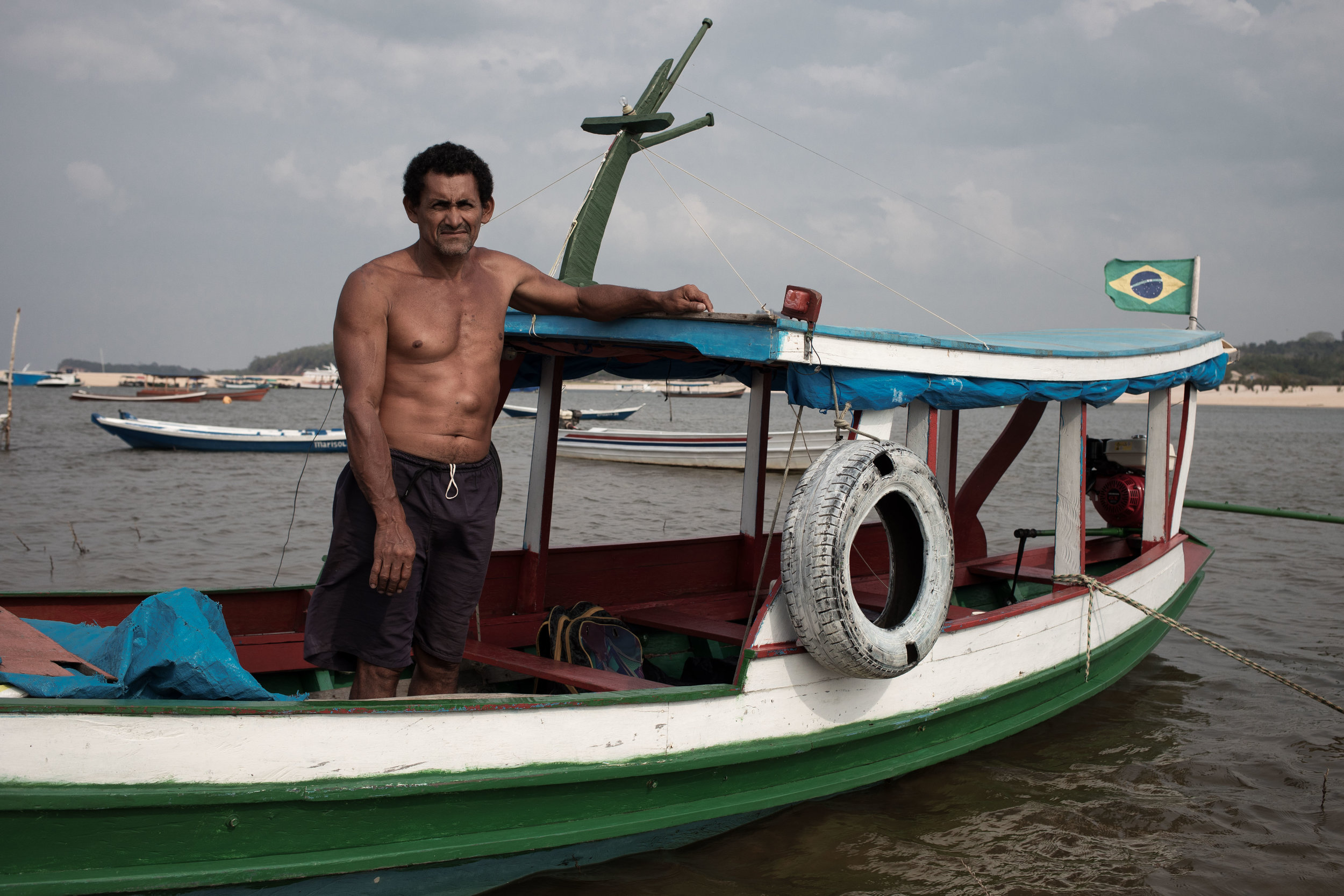 A man stands on his boat in Alter do chão, Brazil.