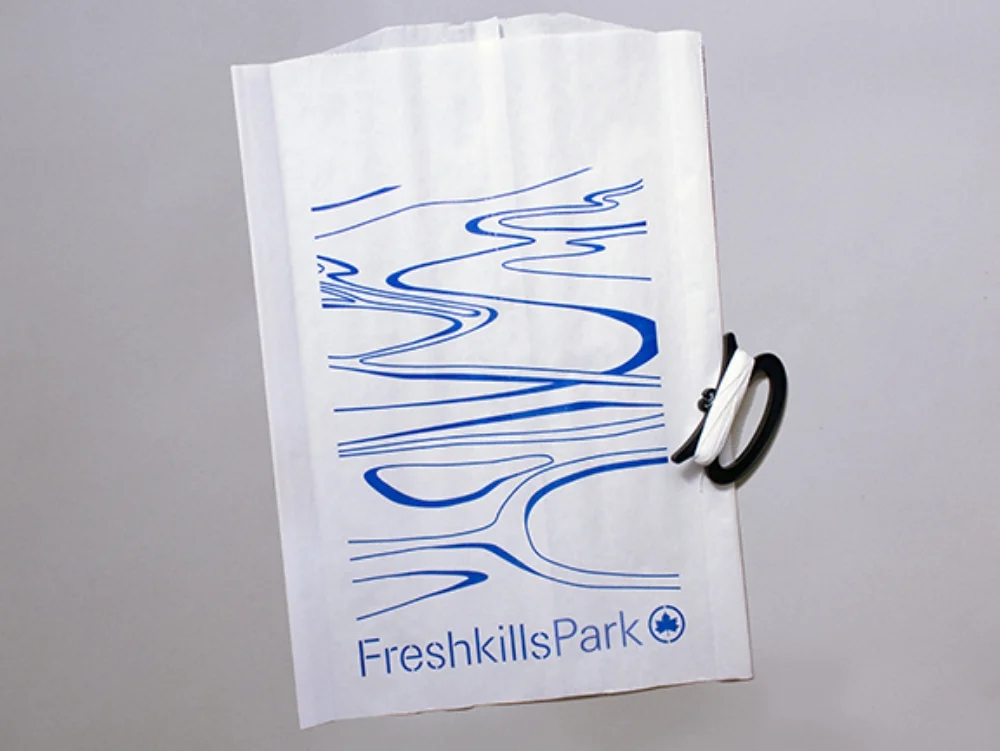 Kite Kit . I conceived and designed these for the inaugural Sneak Peak park preview event, to recreationally activate the main event site, the top of the 150’-tall North Mound at the Freshkills Park site. Kits were composed of paper bags which could be colored on with crayon or marker, then reinforced with cardboard and attached to a spool and a surveyor’s tape tail.