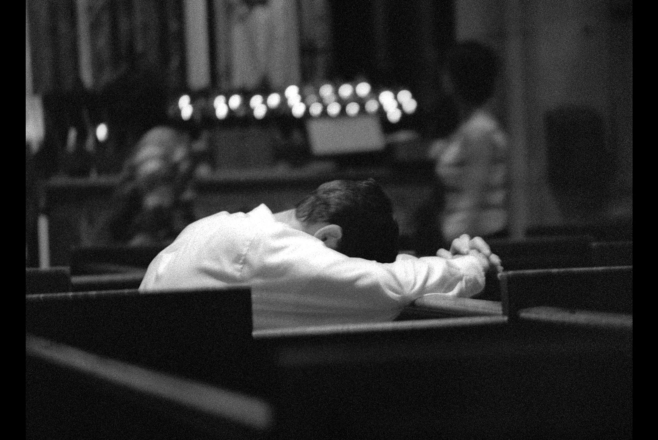 Man Praying with Bowed Head in St. John's Cathedral