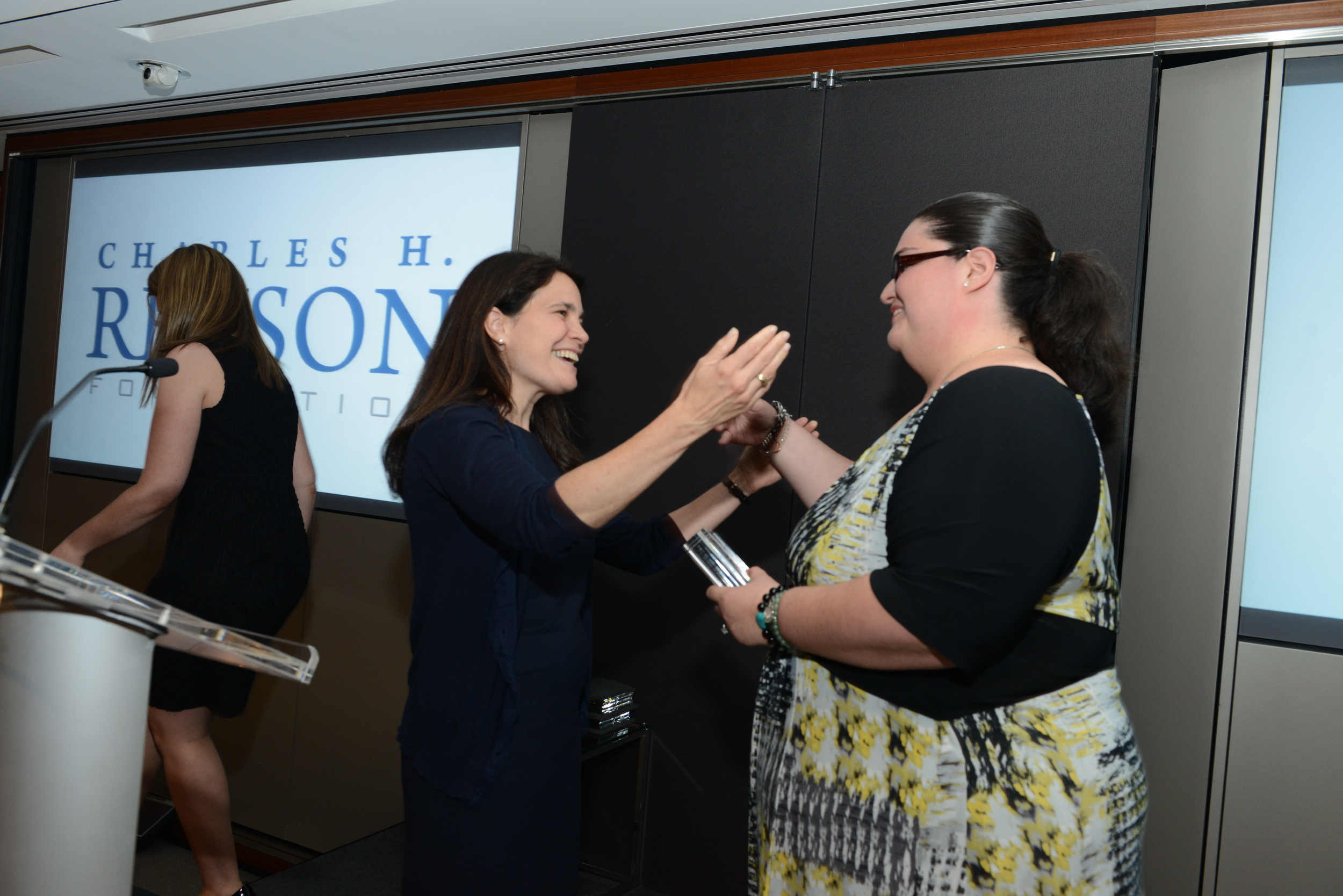 Revson board member Cheryl Cohen Effron presents the New Dorp Library with its award