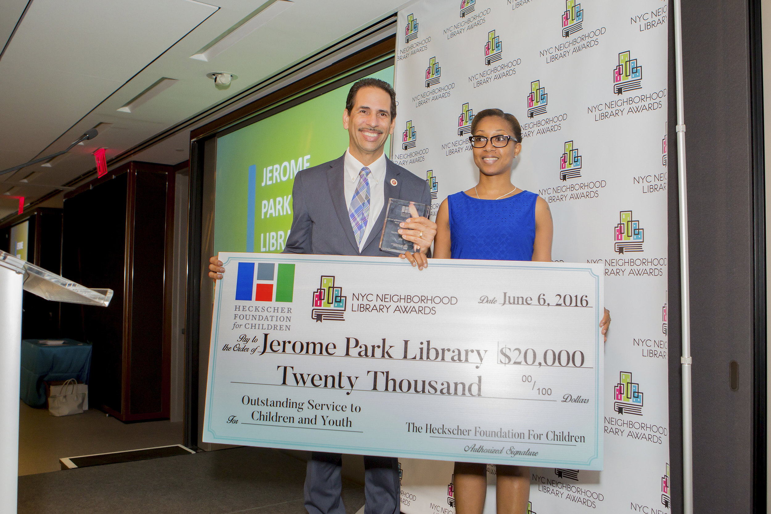 Council Member Fernando Cabrera presents the Heckscher Prize for Outstanding Service to Children and Youth to Nicola McDonald, Manager of the Jerome Park Library