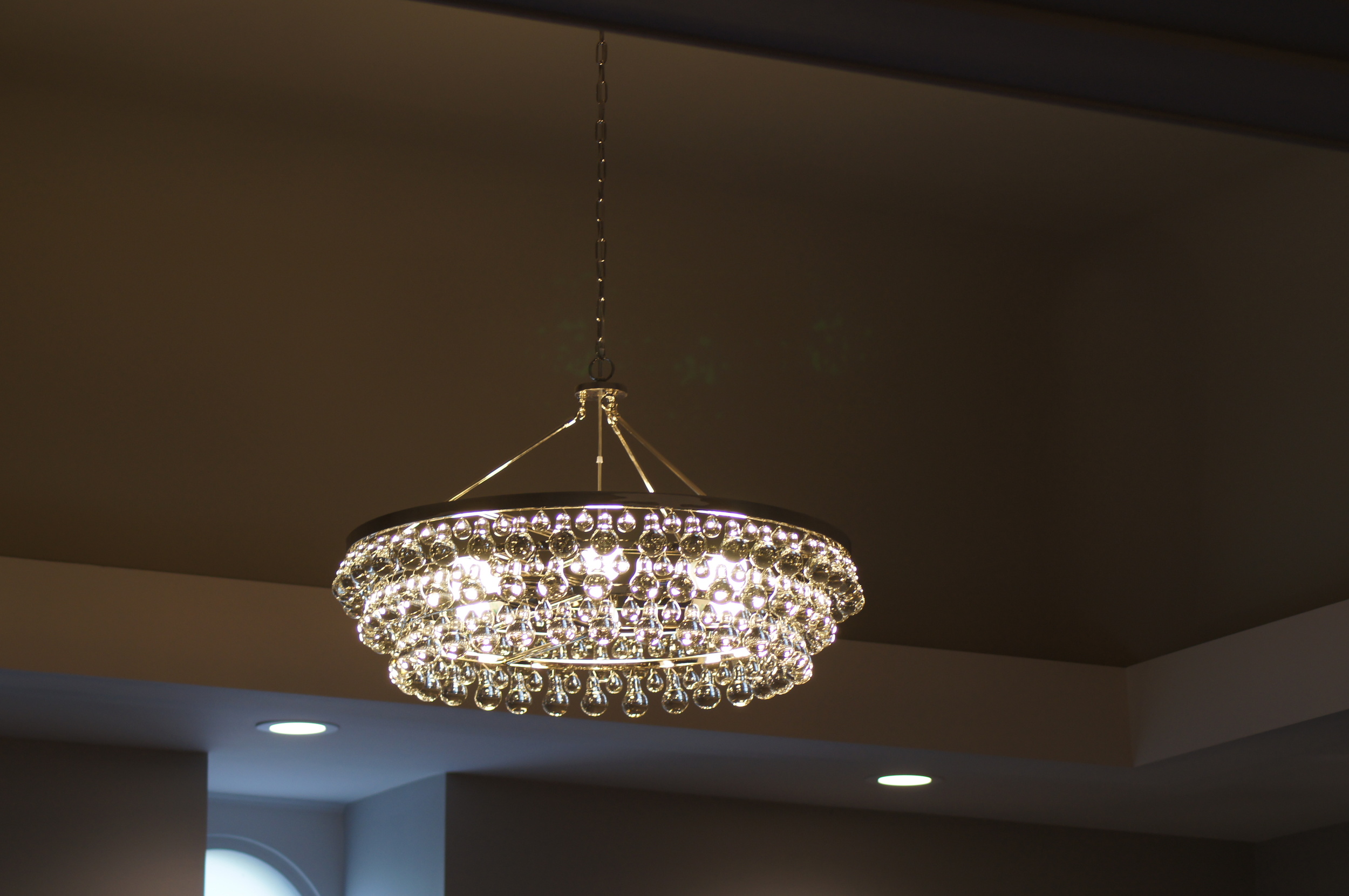 AFTER: CEILING COVE + NEW GLASS BULB CHANDELIER CEILING ARCHES WERE CUT OFF, POPCORN CEILING FINISH WAS SCRAPPED AND A DARKER PAINT WAS APPLIED INSIDE THE CEILING COVE ALONG WITH ADDITIONAL LIGHTING + TRIM TO FINALIZE THIS BEAUTIFUL ARCHITECTURAL DETAIL