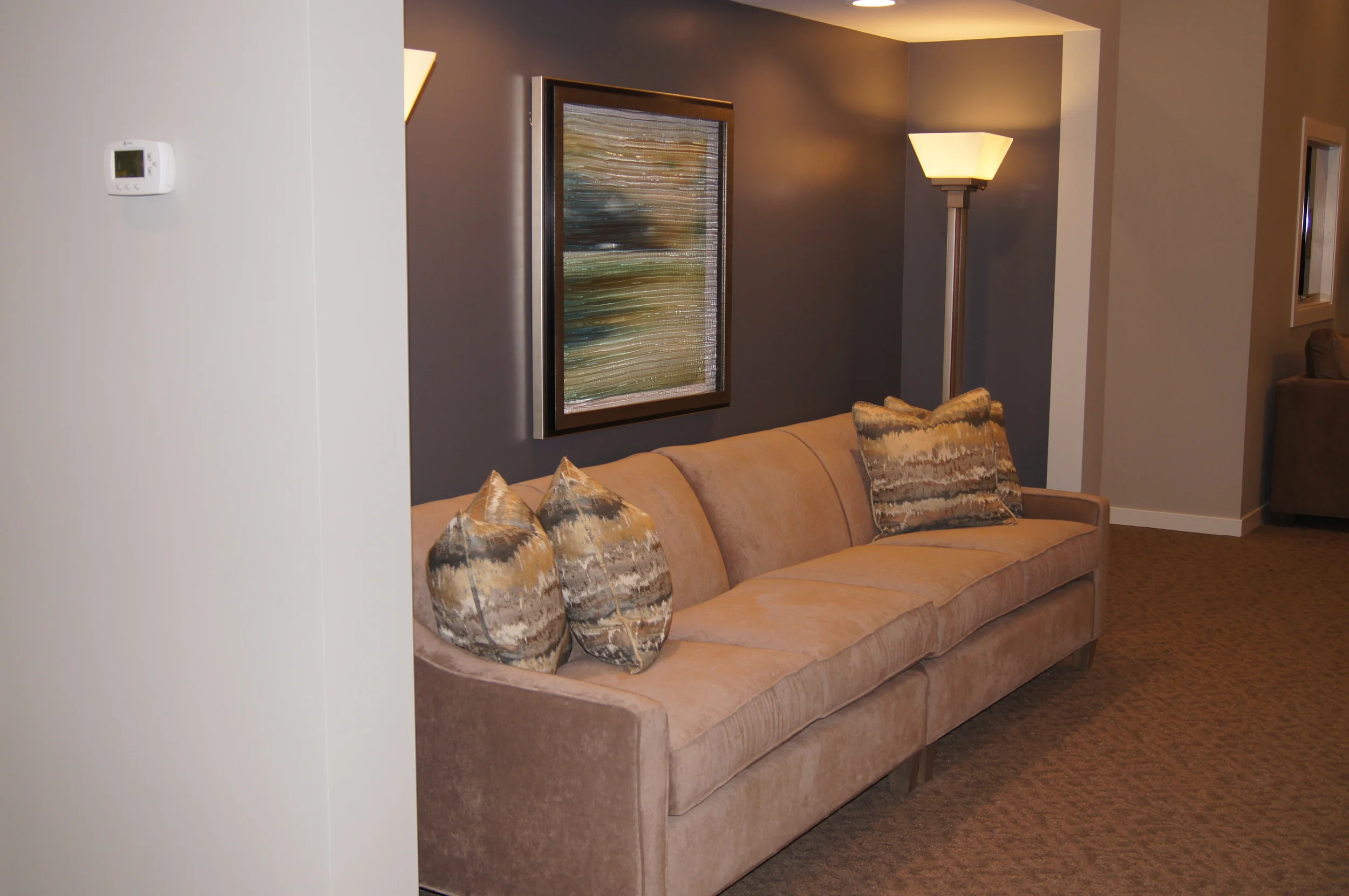 AFTER: CHAPEL ROOM CLOSET DOORS WERE ELIMINATED AND WE CREATED A SEATING COVE WITH AN INSET OF A DARKER PAINT + LIGHTING + A BEAUTIFUL PIECE OF ARTWORK