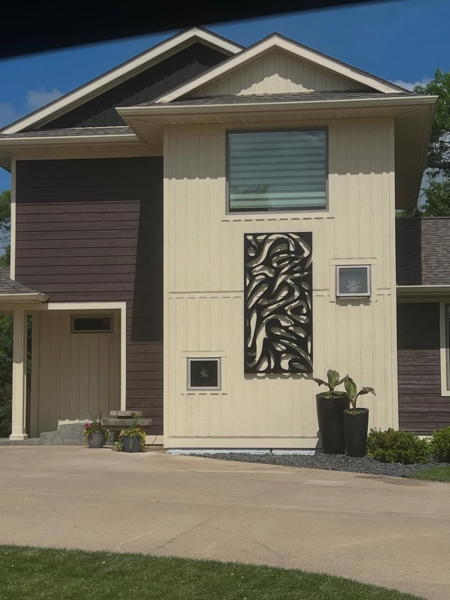 OUTDOOR ART. Who says you can&rsquo;t display a cool piece of art outside?

This client was looking for something unique to highlight the modern design of their home. After a some searching, I was able to source this piece of metal art that can withs