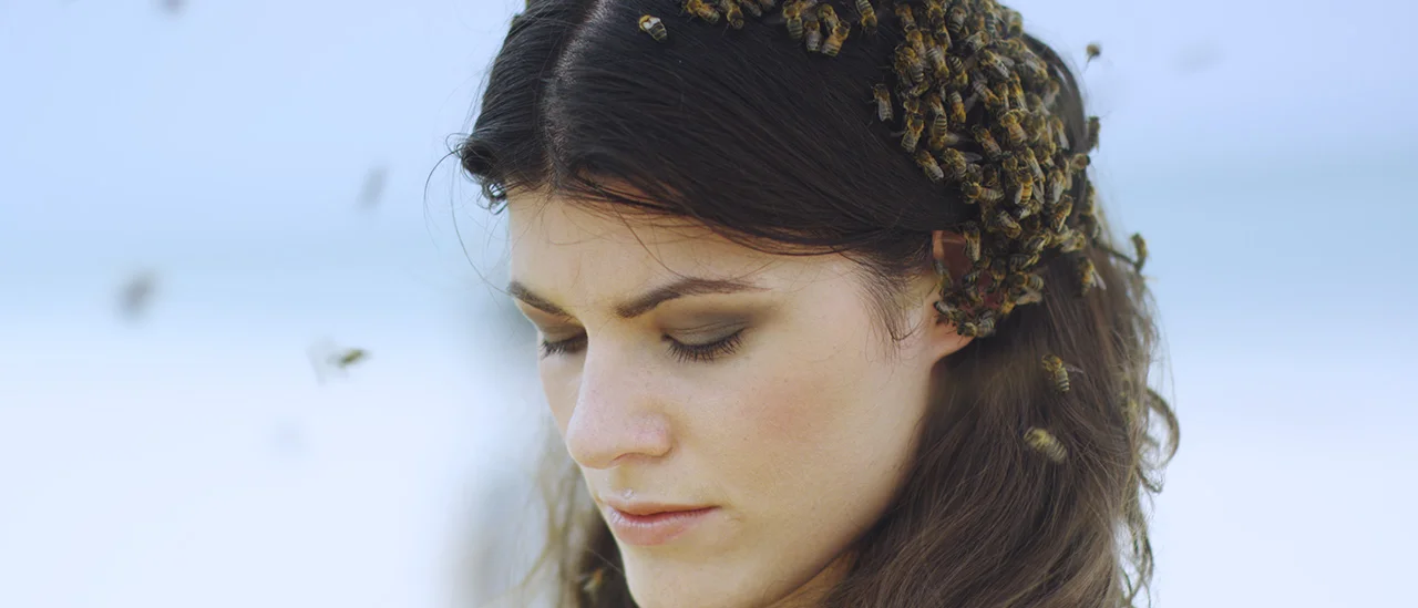 On the second day of shooting, the bees were more attracted to my hair than my body, so I ended up wearing a "bee bonnet". I had washed my hair the night before with an unscented shampoo, but perhaps it was enough scent for the bees to be attracted to the smell! Photo: Clayton Haskell 