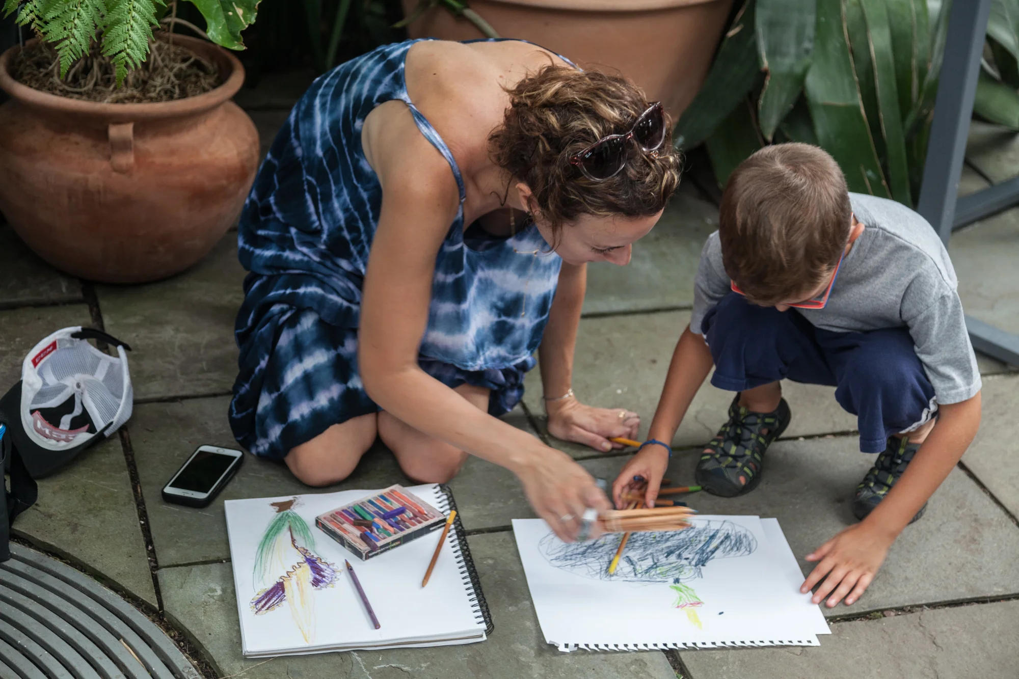 A mother and son do their best artistic inspiration of the corpse flower ( Amorphophallus titanum ) in bloom, memorializing the moment in colored pencils and pastels. 