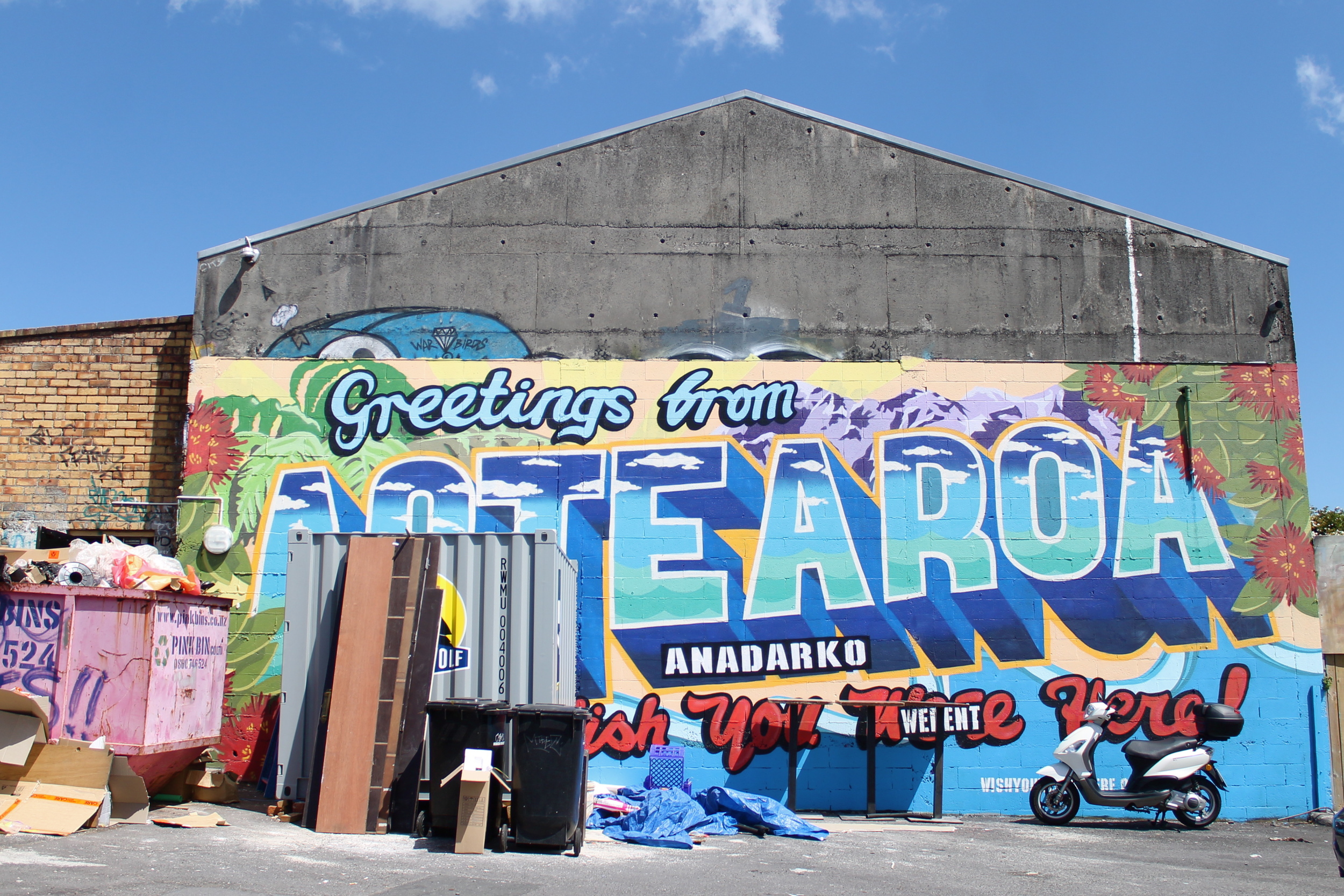Aotearoa = Maori word for "New Zealand". Literally meaning, "land of the long white cloud" because of the shape of the 2 islands. Bit of a mixed message from this graffiti... 