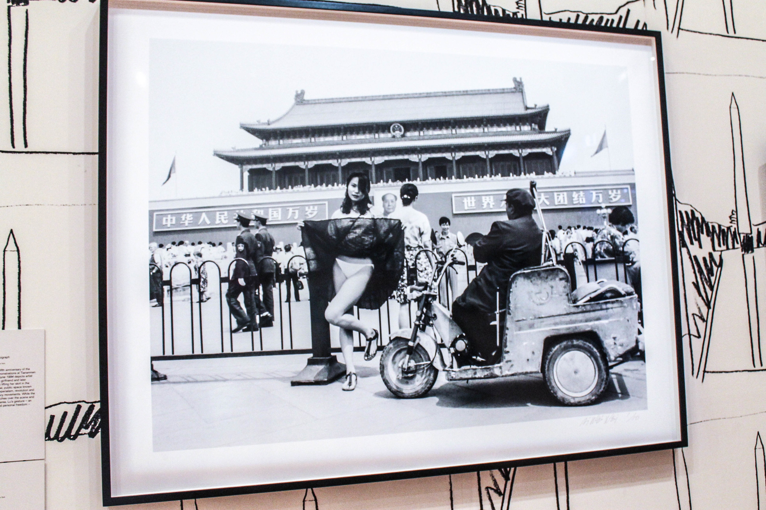 Ai's wife, Lu Quing, lifting up her skirt at Tiananmen Square. 