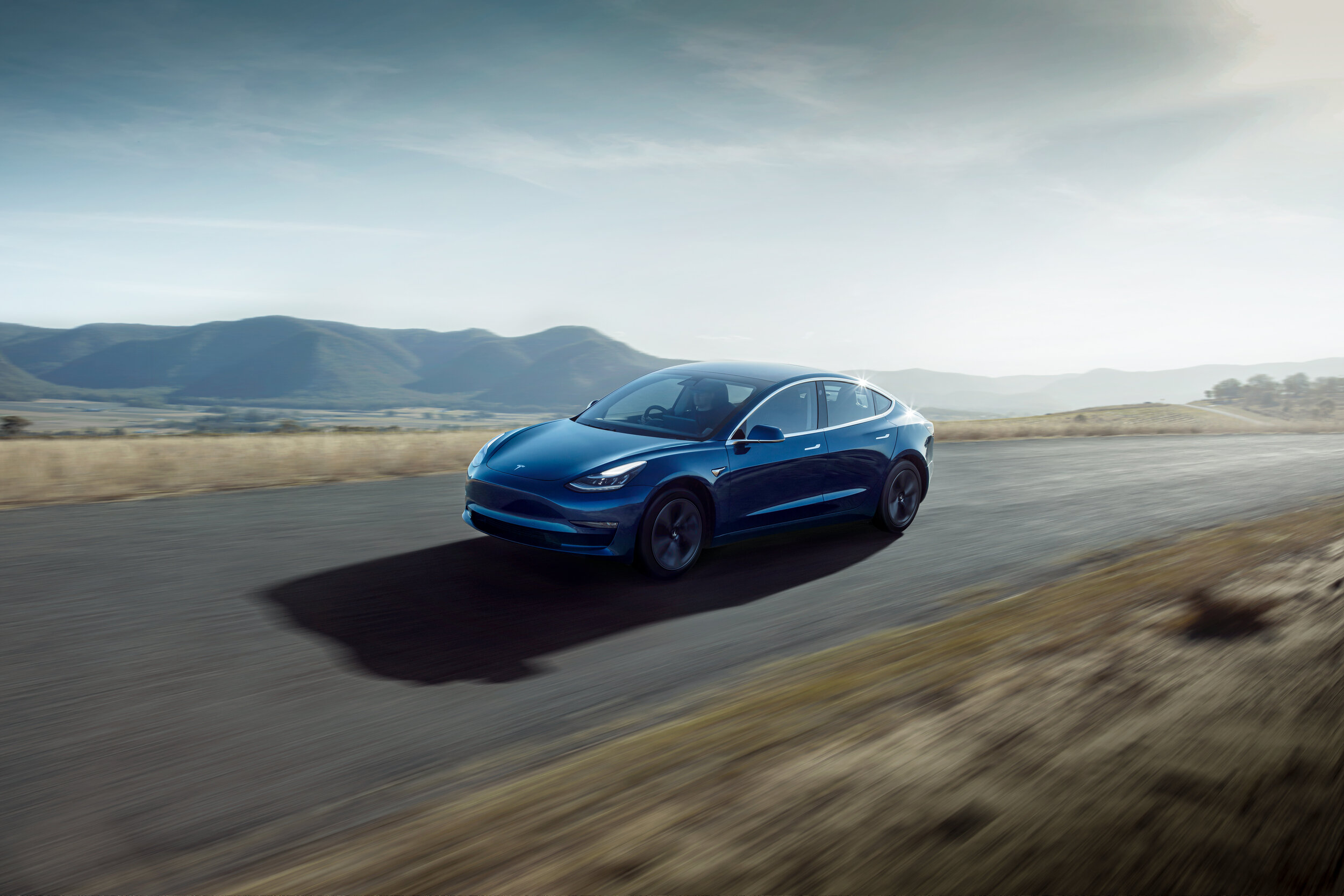 Model 3 Right Hand Drive Blue Driving Front Quarter