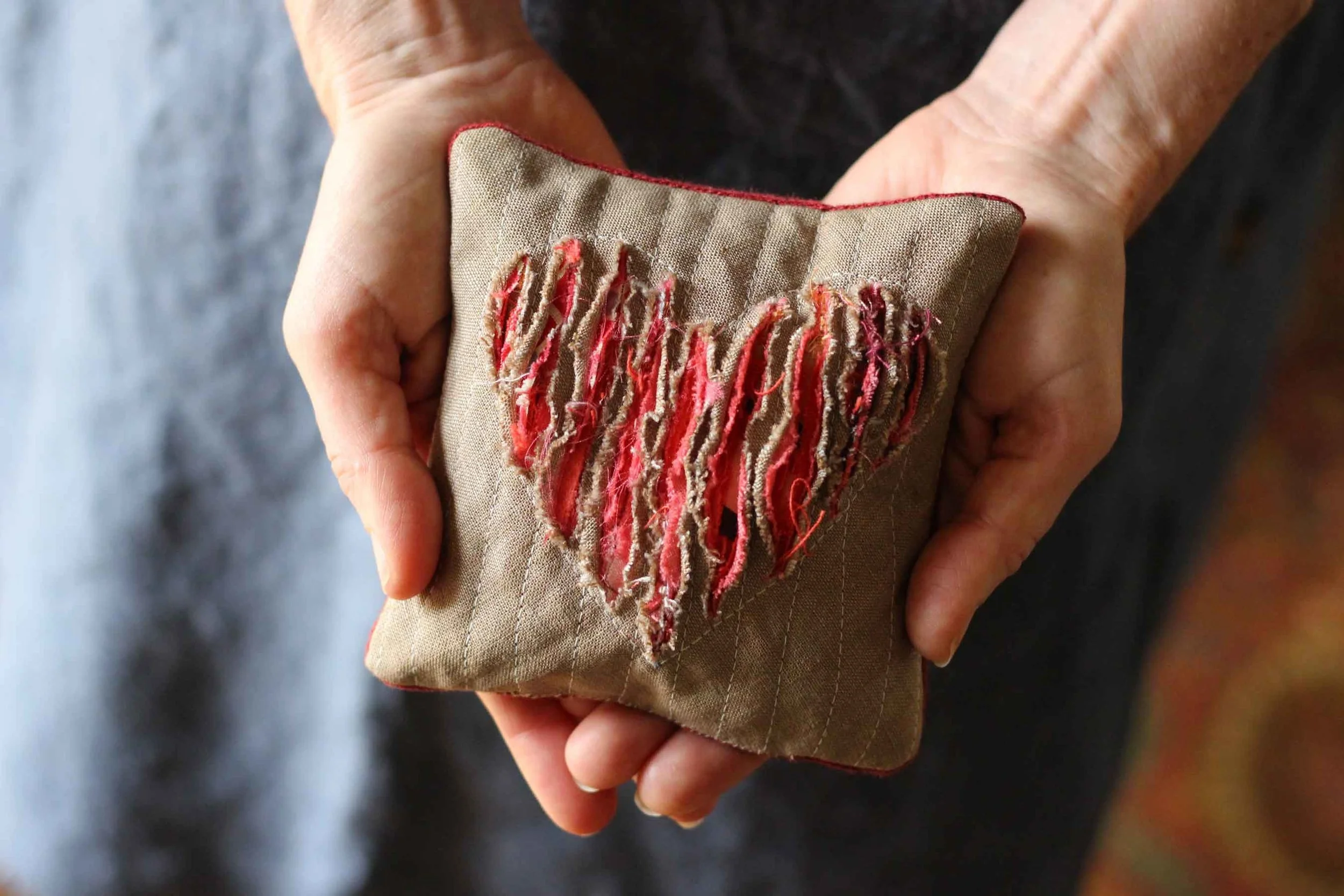 A hand warming pillow with a heart slashed into it for Valentines Day. Warm hands, warm heart. Learn how to do this slashing technique at Thread & Whisk.