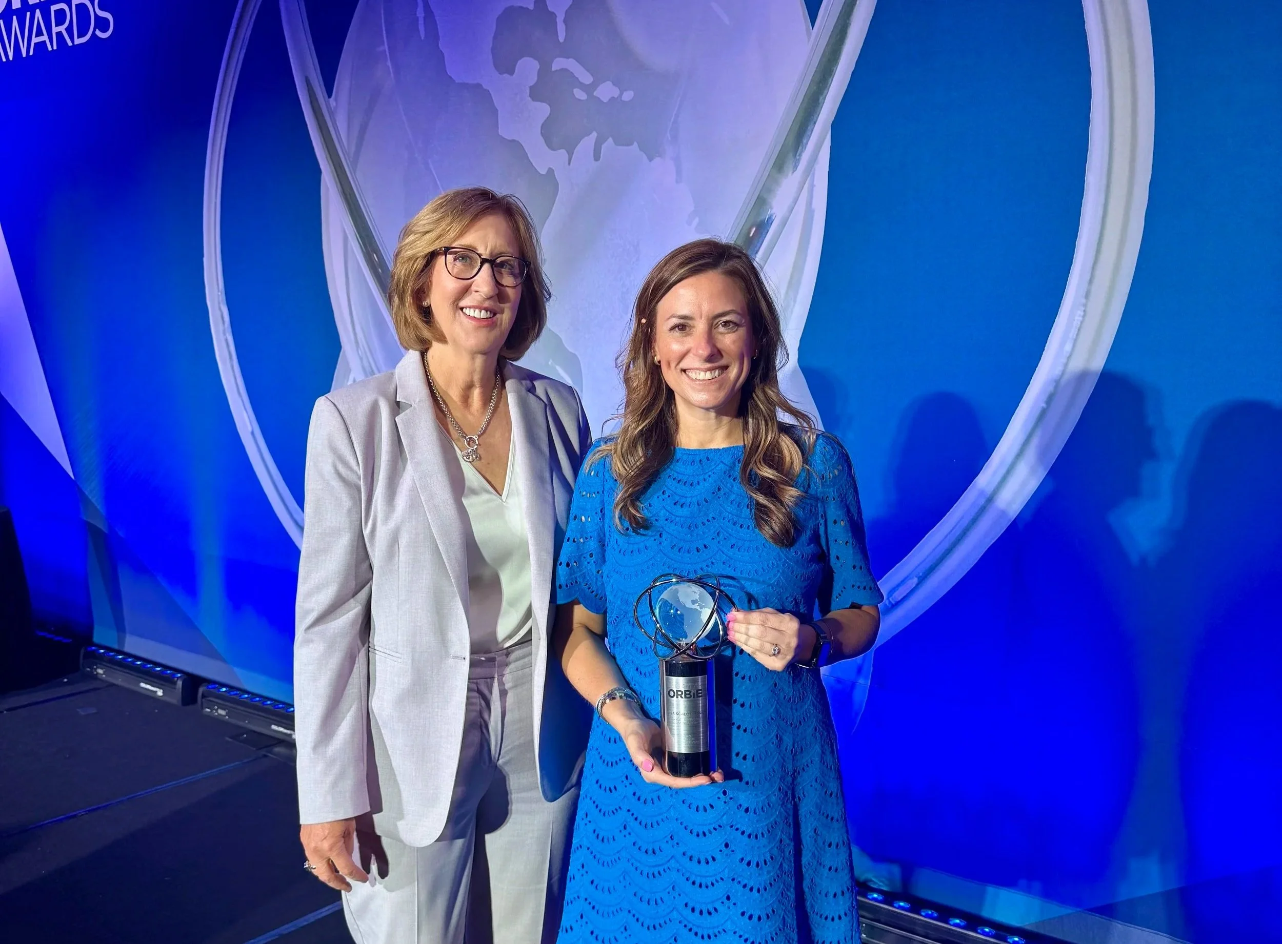 Lisa Schlossberg with Lynn Stith Bennett, CEO of CapitalCMO, following the 2026 CapitalCMO ORBIE Awards ceremony.