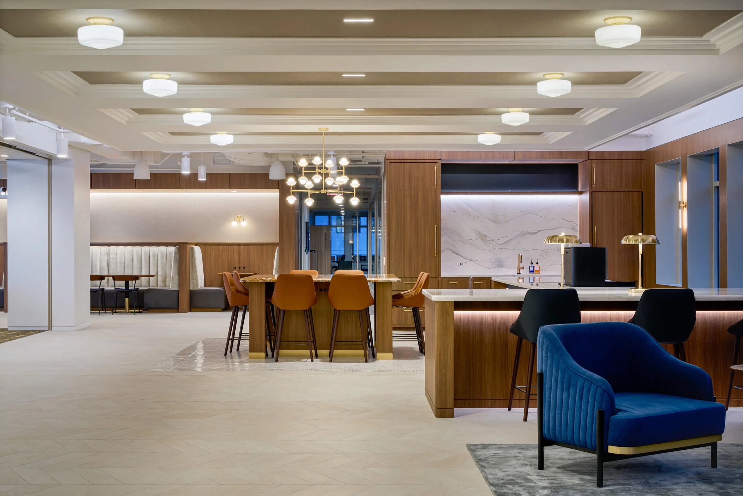 Renovated corporate office lobby with custom millwork, collaborative seating, and modern interior finishes completed by Coakley & Williams Construction.