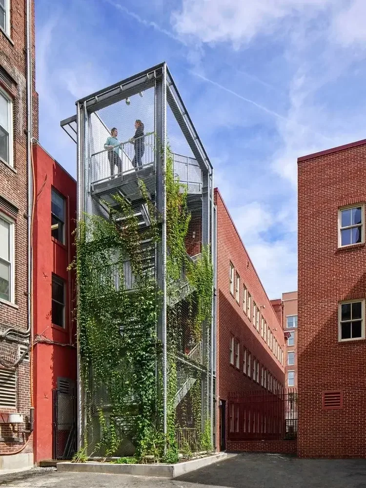 Exterior green stair tower at ASLA Headquarters showcasing sustainable building design completed by Coakley & Williams Construction.