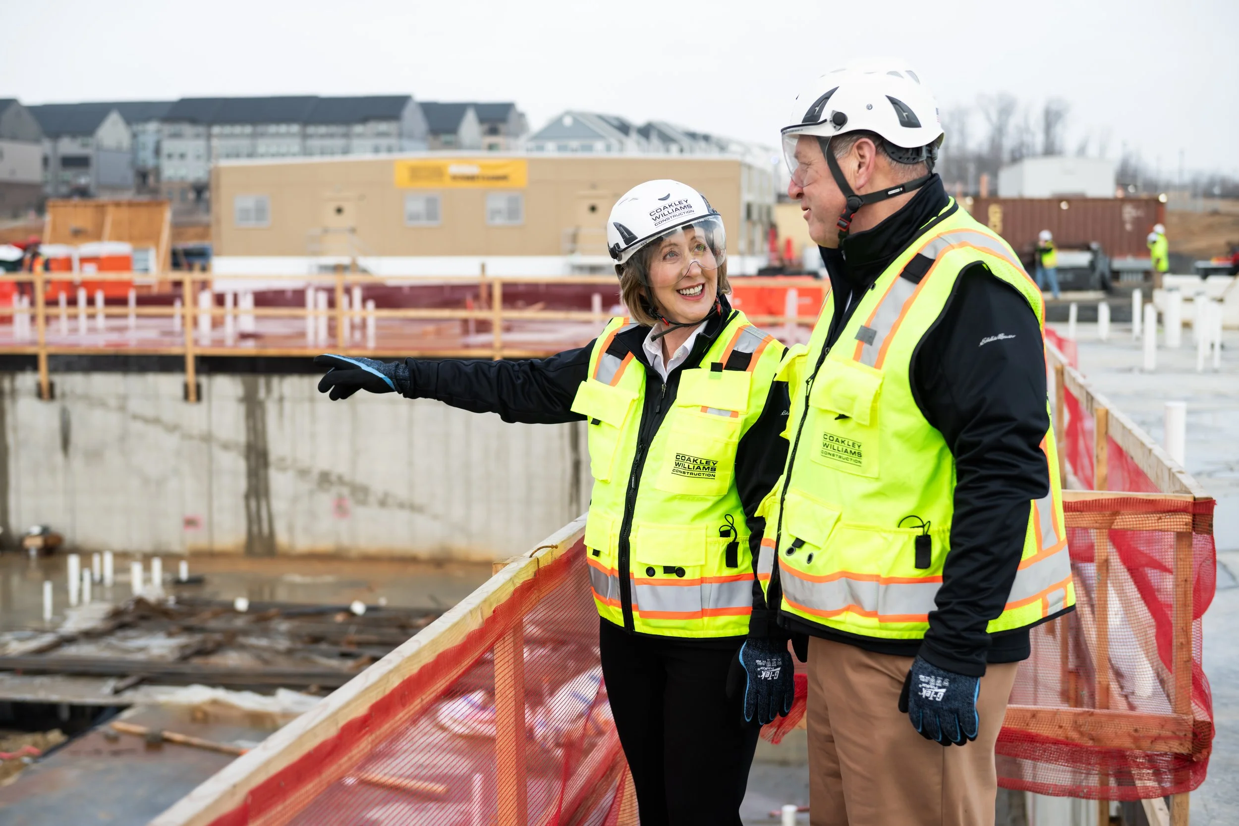 Coakley & Williams Construction leaders discussing progress during a jobsite walkthrough.