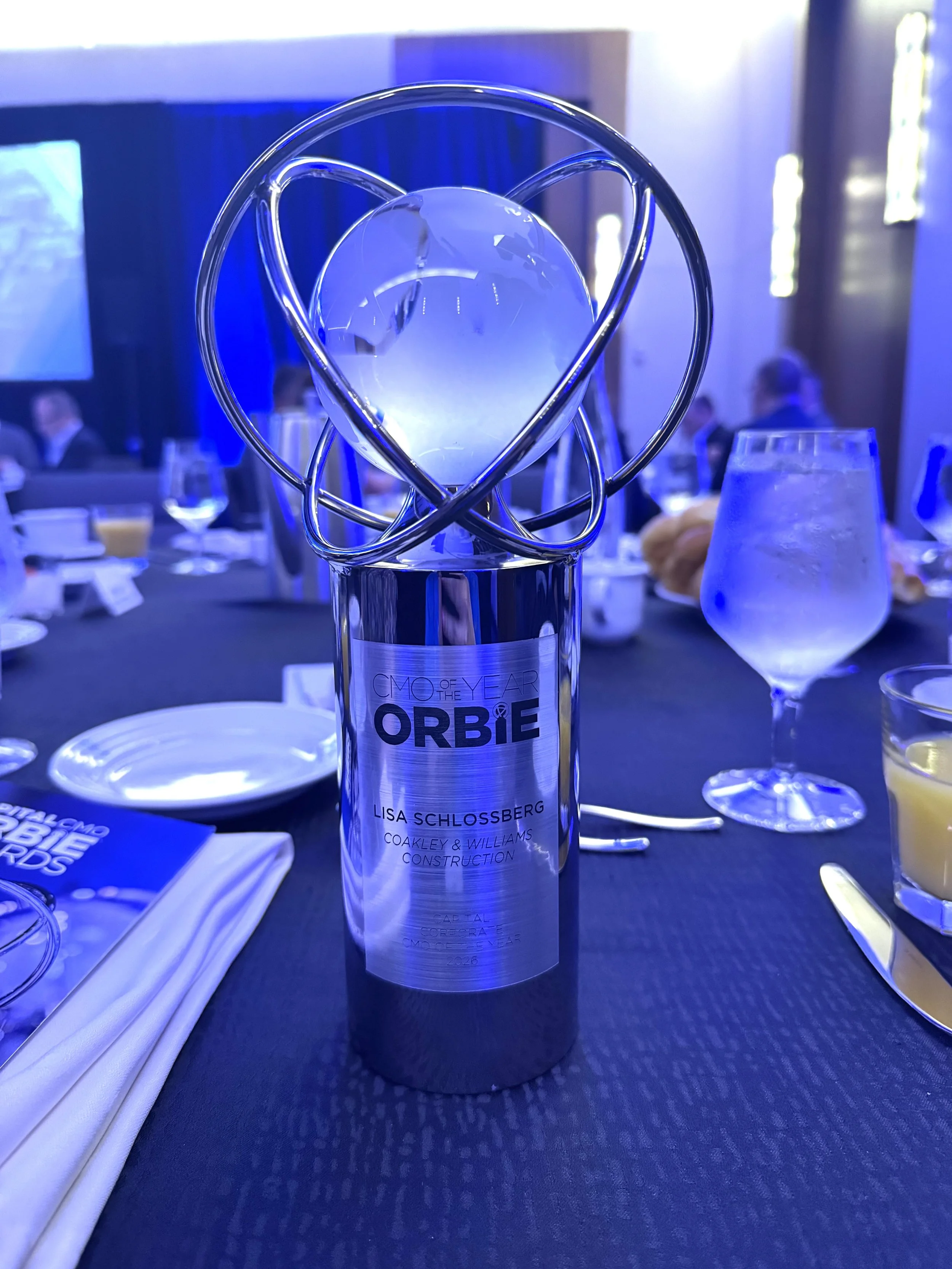 2026 CapitalCMO Corporate ORBIE Award presented to Lisa Schlossberg of Coakley & Williams Construction.