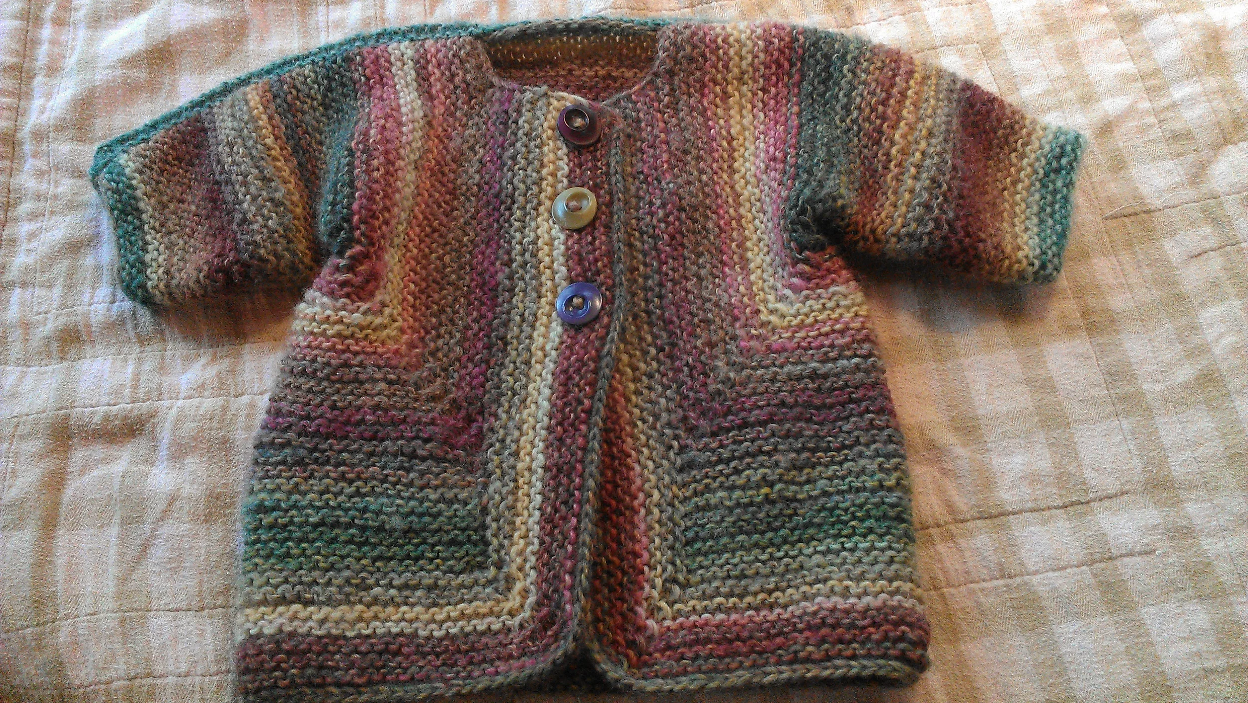 Baby Surprise Jacket, a very fun pattern. Knitting this is an exercise in trust that's been amazing knitters for years!