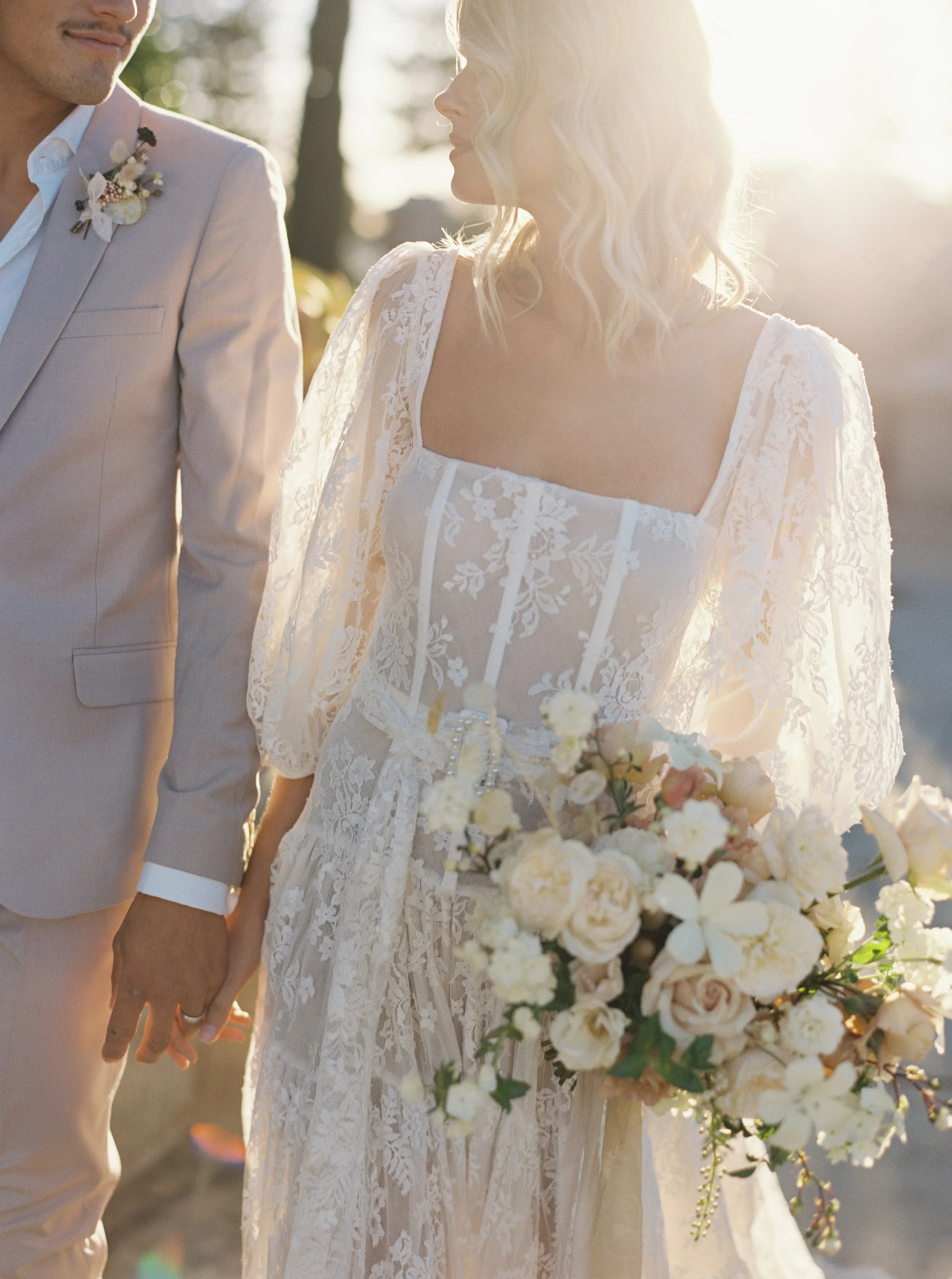 a lace gown glowing in the perth sun at cottesloe civic centre with organic bouquet and flowers captured with film photography