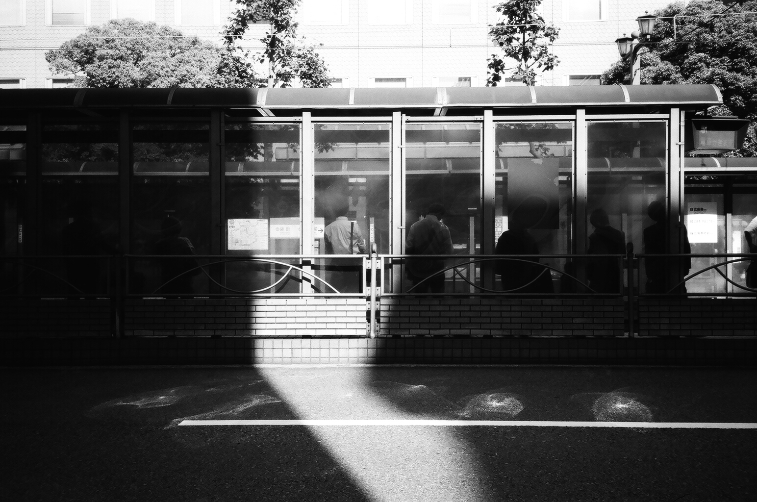  Sunlight dances through the panes of glass&nbsp;at a streetcar stop in central Hiroshima. The city has one of the most extensive networks of streetcars in Japan. Two Hiroden streetcars that survived WWII are still in operation today. 