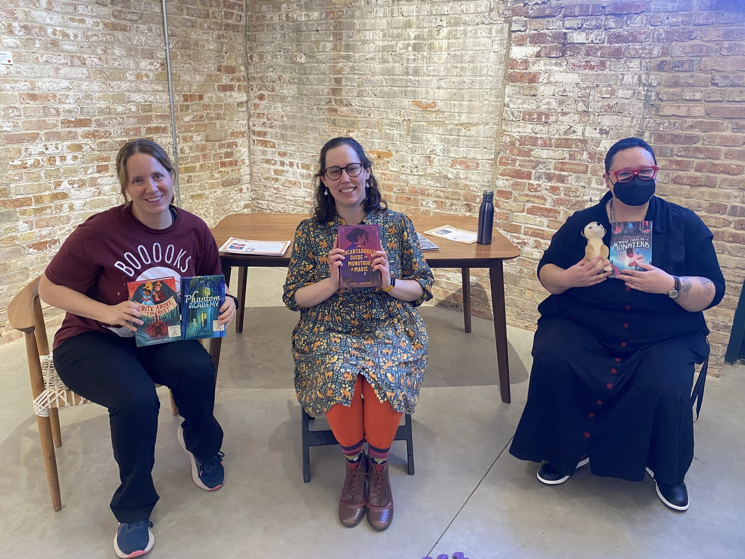 Sarah J. Mendonca with a copy of An Encantadora's Guide to Monstros and Magic at the Garver Feed Mill Kids' Book Fest