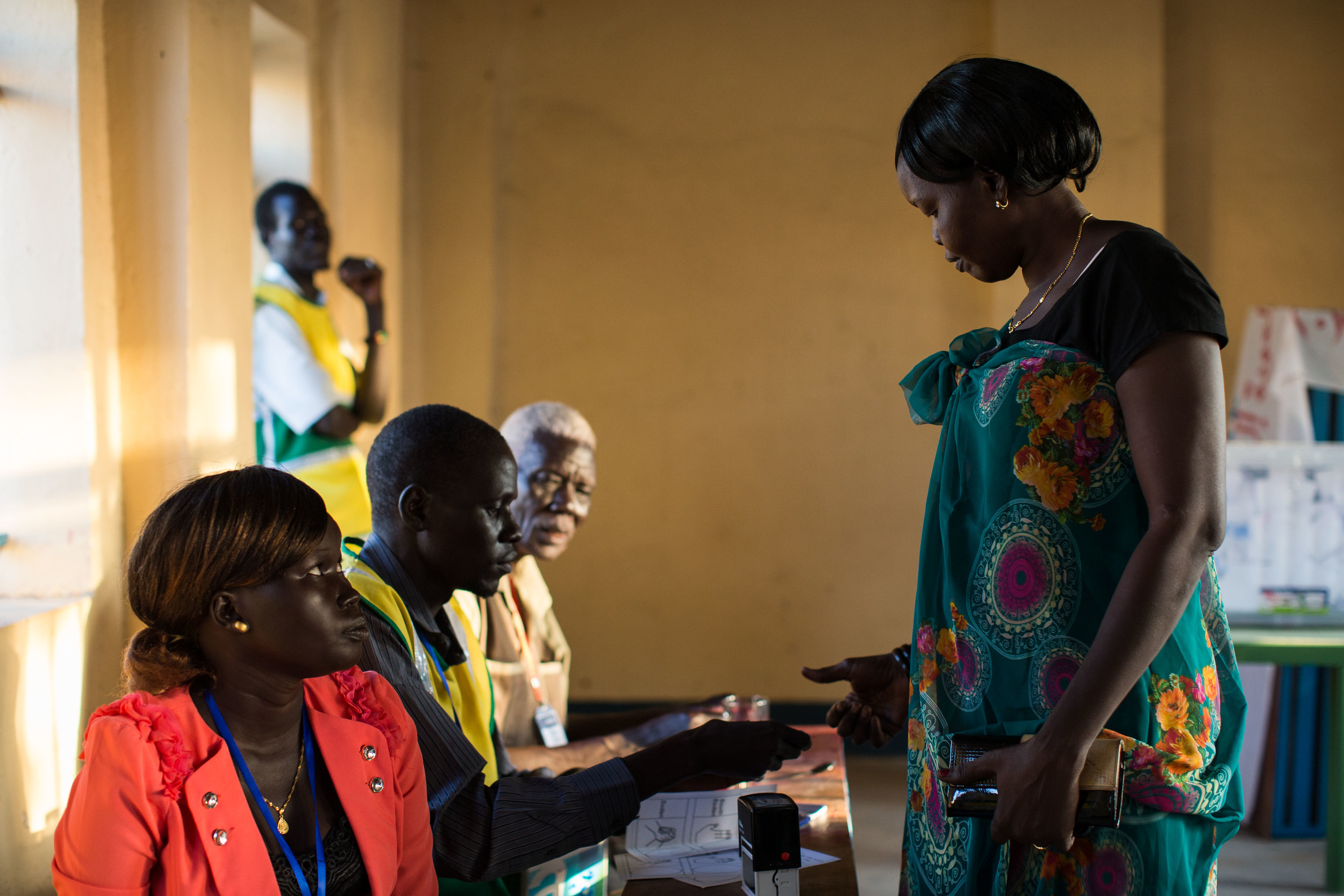  A woman receives her ballot from a volunteer for the Abyei Area Community Referendum Commission (AACRC) &nbsp;at a voting center in Abyei.    
