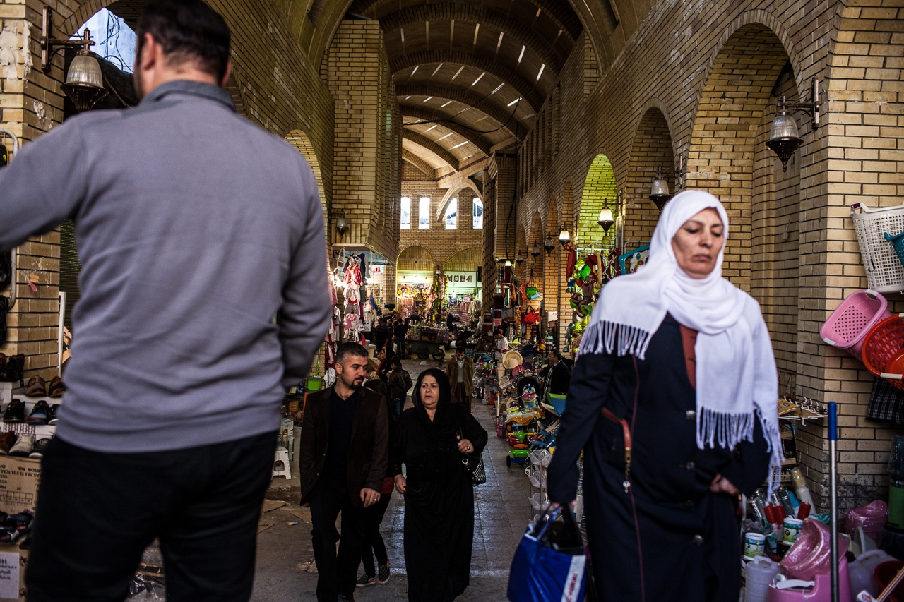 Shoppers walk through the ancient marketplace of Erbil.