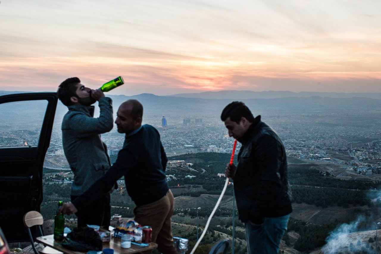 Young Kurdish men drink beer and smoke a water pipe atop a mountain overlooking Sulaymaniyah.
