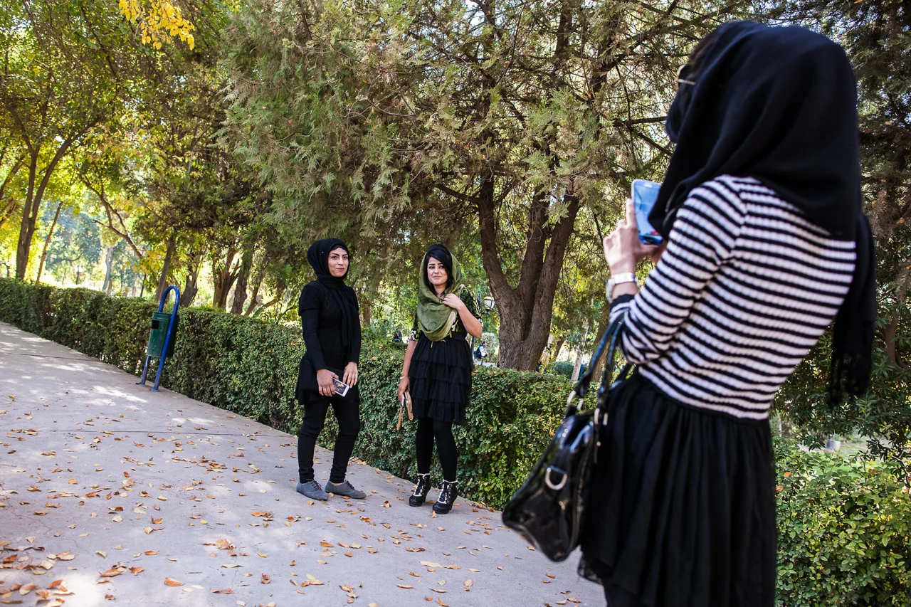 Young Kurdish women have their photo taken by a friend in a park in Sulaymaniyah.
