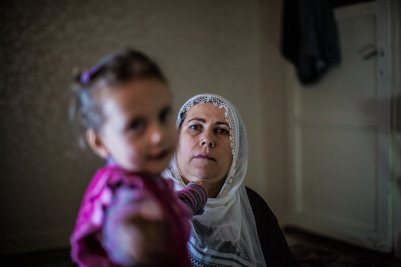 Suleman's mother, Nezhat, sits with her daughter in their home. "Being Kurdish is my history. It is my being and it is my life," she says, "Now when my two other boys go out its really hard for me. I feel crazy until they come home. We want a life for our children without any war without any worry without any fight. We want peace for our children."