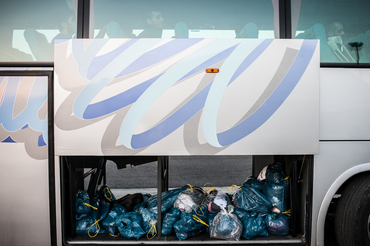 The belongings of migrants rest in the luggage container of a bus that will transfer them to a temporary holding camp. With few guards, most migrants who don't want to register for asylum in Italy will escape from this camp within 48 hours of arriving.