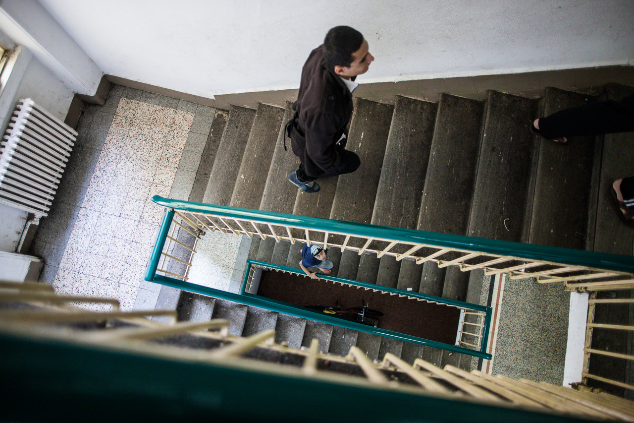 Transiting Syrian refugees walk the stairwell of a temporary camp in Milano. Since October 15th, 2013 the Milano Municipality has officially registered 45,876 transiting refugees from Syria, Palestine, and Eritrea.