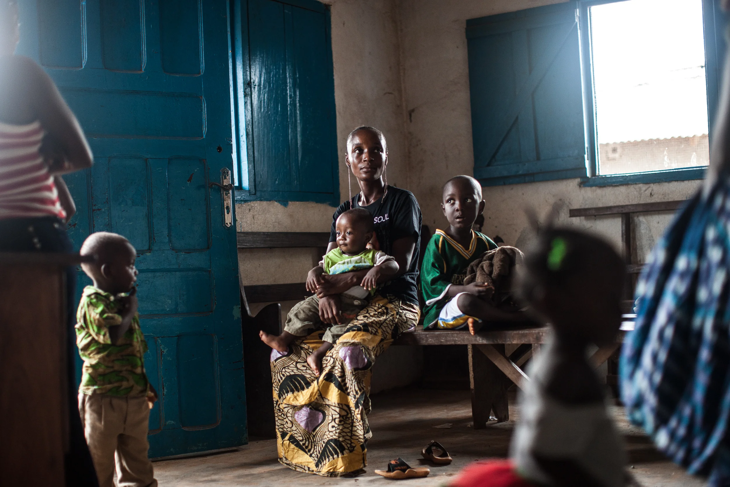  A mother waits to have her sick son seen at the clinic in Pleebo, Maryland County, Liberia, Friday, May 22, 2015. CREDIT: Mackenzie Knowles-Coursin for The Wall Street Journal. EBOLAREBUILD 