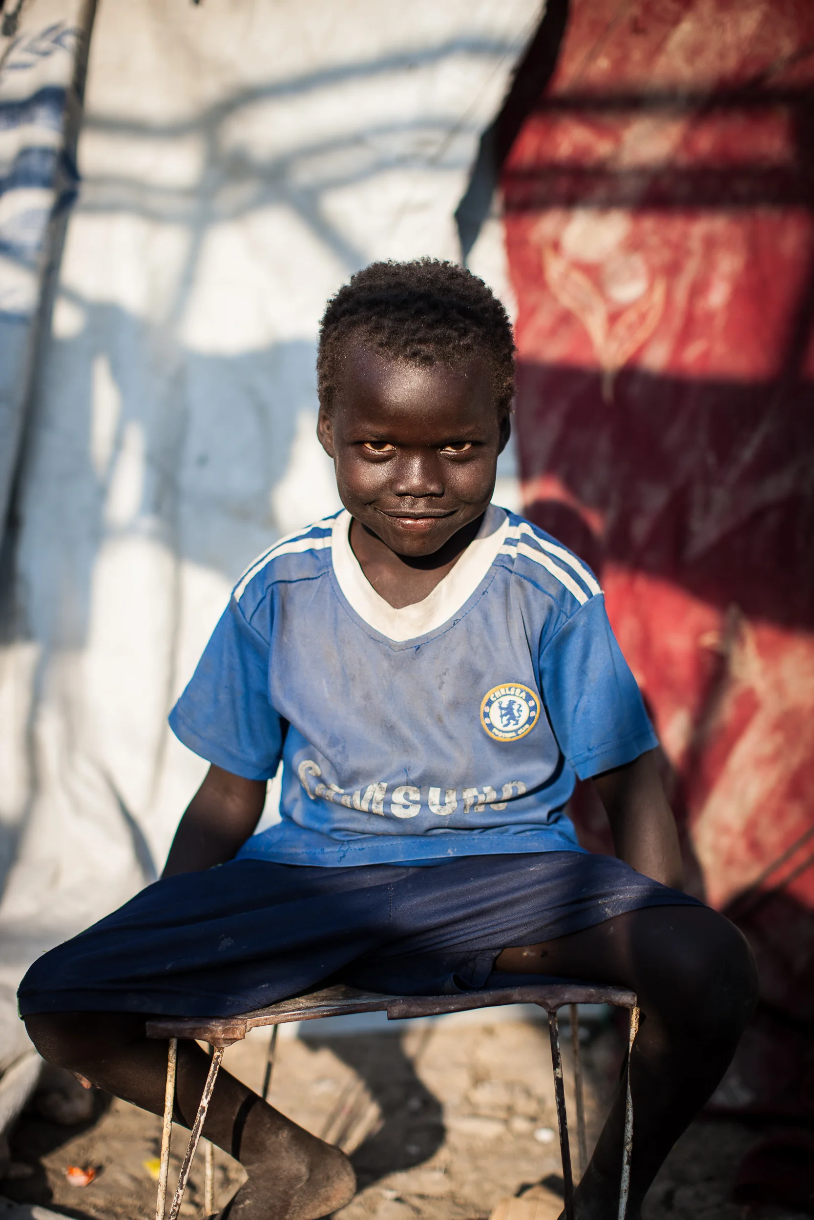 Sebit, 5, sits in the Malakal PoC where he now lives.