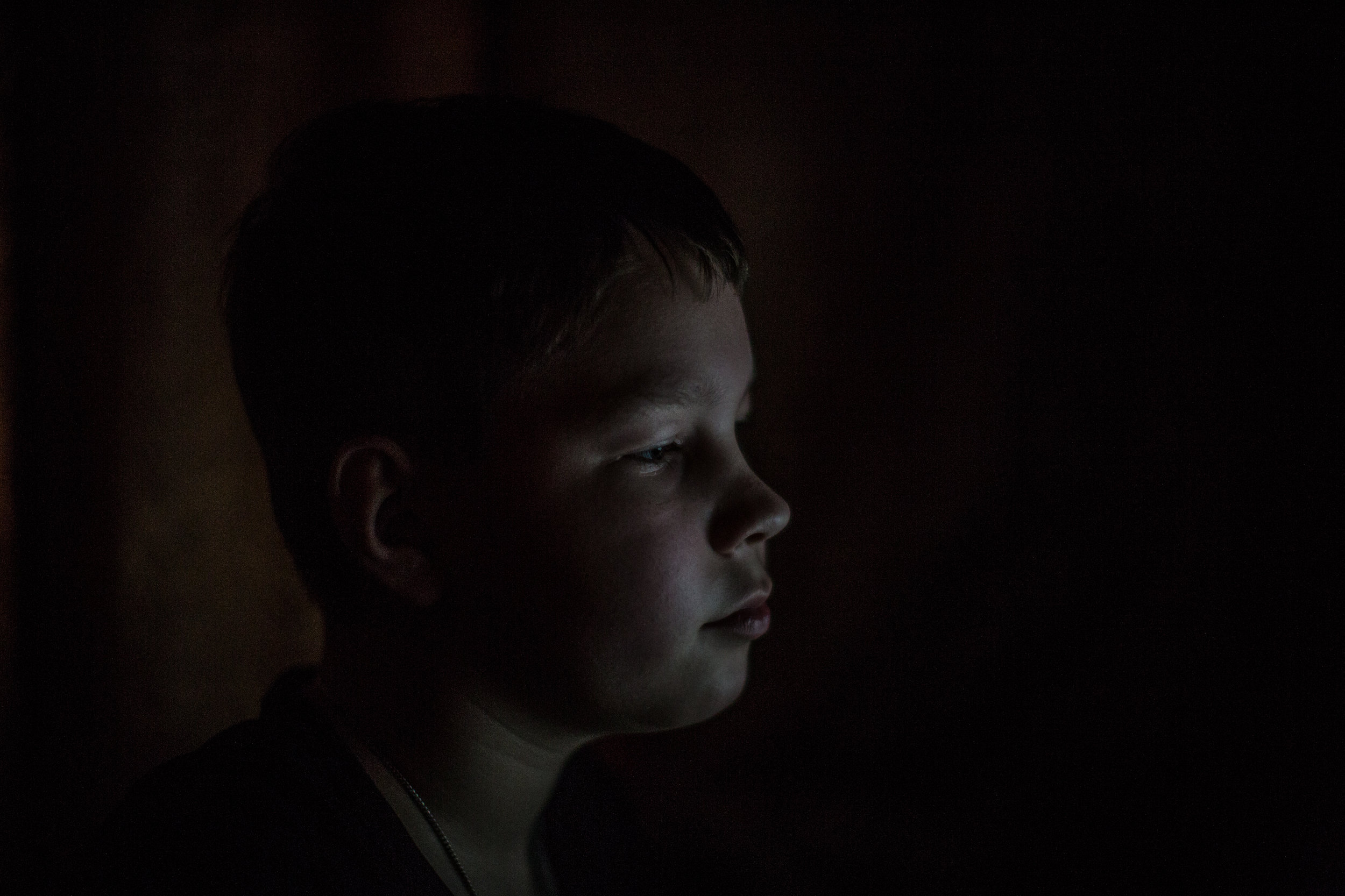 Kostya's brother, Artyom, 10, sits at home in his room. "Everything we have done, we have done for our children," says the Artyom and Kostya's father, Sasha.