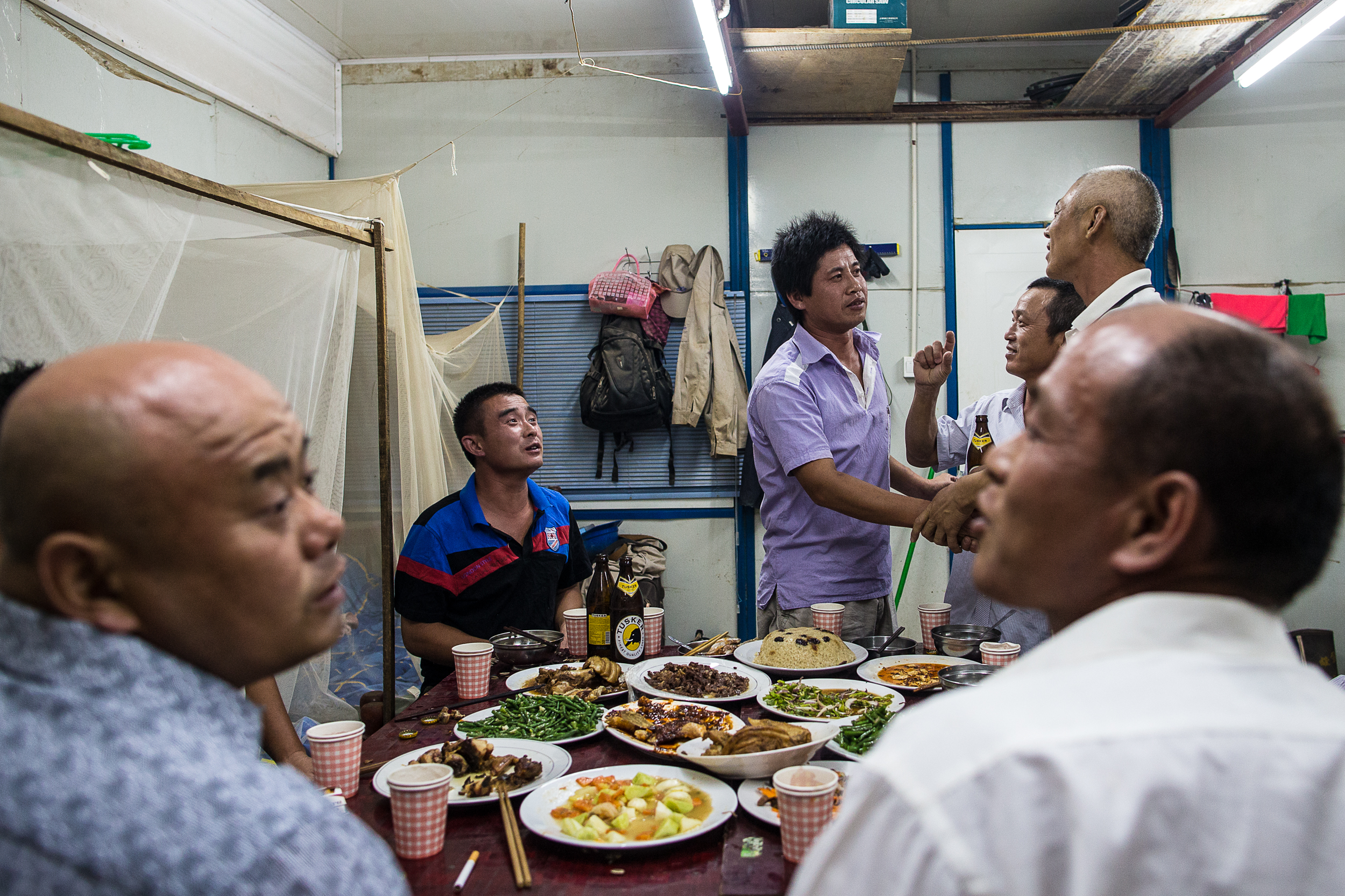 Engineers and laborers celebrate the New Year in the Chinese laborers quarters. Laborers and management live separately.