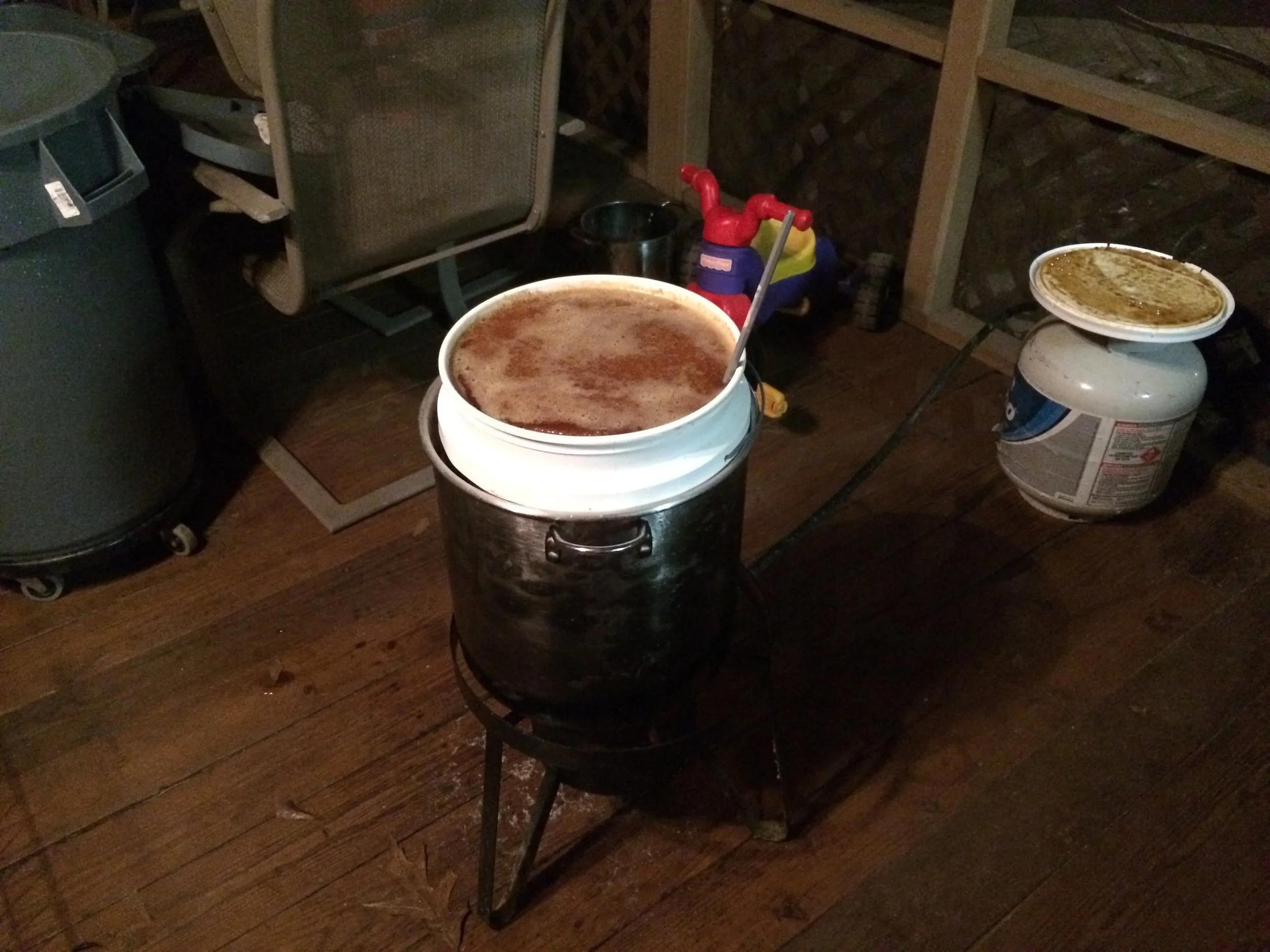 This is my setup for heating a bucket. Kids toys optional. As you can see, this bucket has started to liquefy but is still very gritty. The bucket just fits inside the pot. Fill the annulus between the bucket and pot with water for optimal heat dispersion. 