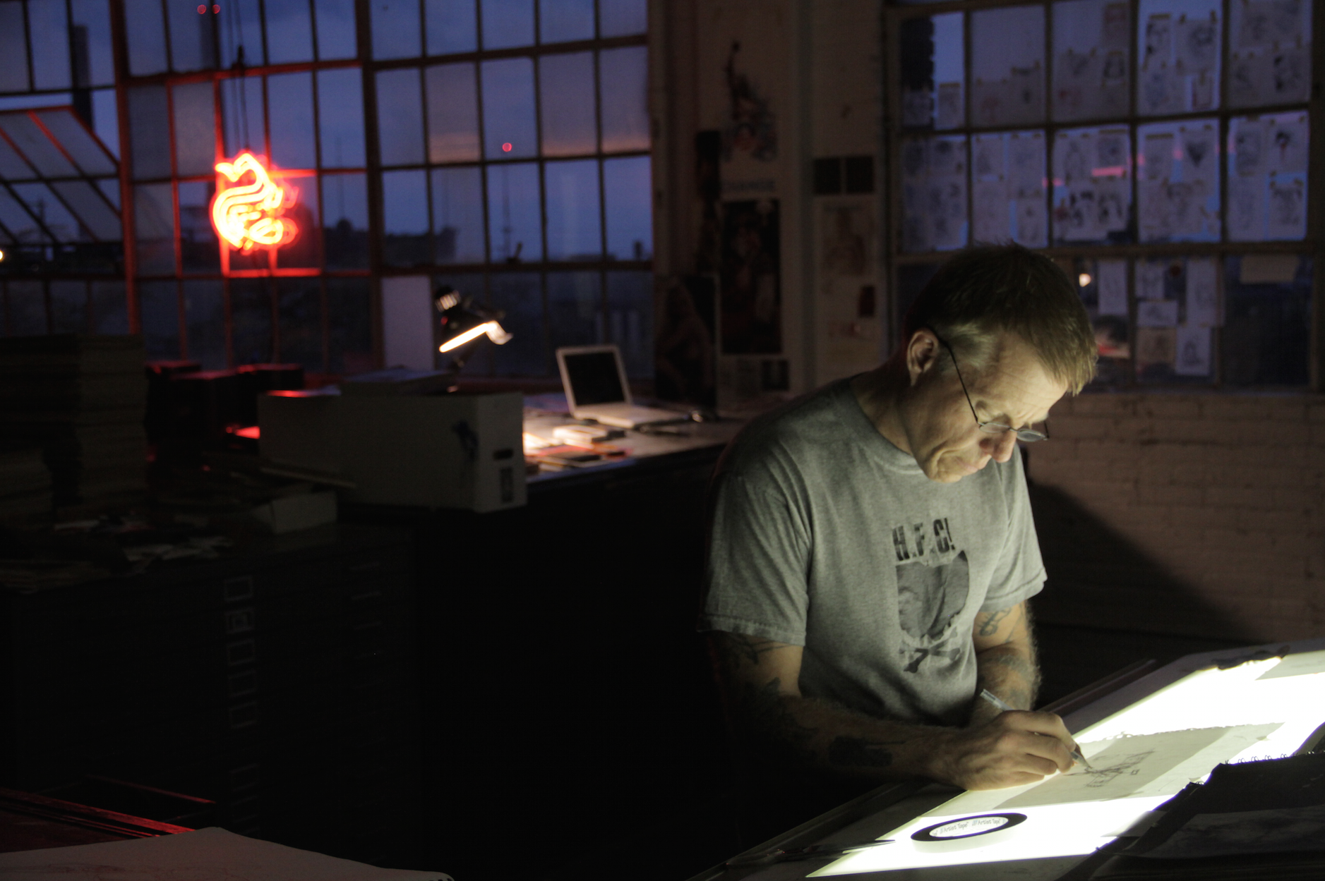 Derek Hess drawing in his studio