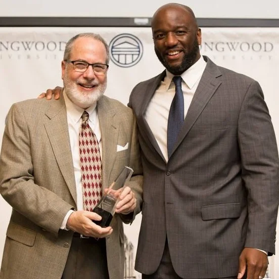 Michael receiving the Nunally Award at Longwood University from Troy Austin, Director of Athletics, for the positive impact Michael's sports psychology has on the lives of the university's scholar-athletes.