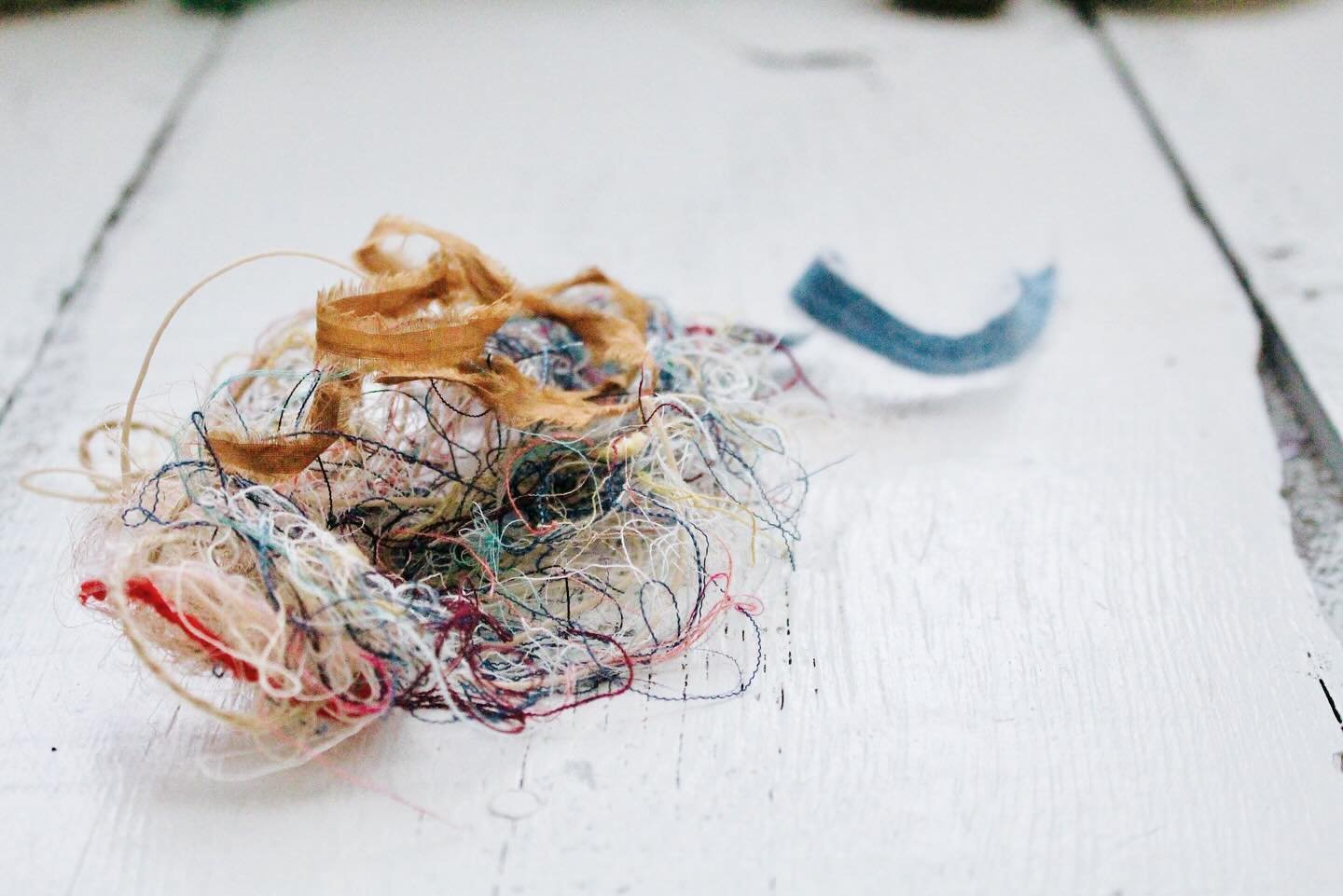 &bull;
Once all the Mending Space kits have been assembled, packaged, and shipped to the four corners, one of my favorite things to do is gather the stray threads I pulled into a loose pile. In this tangle of tattered textile strands, I find an assem