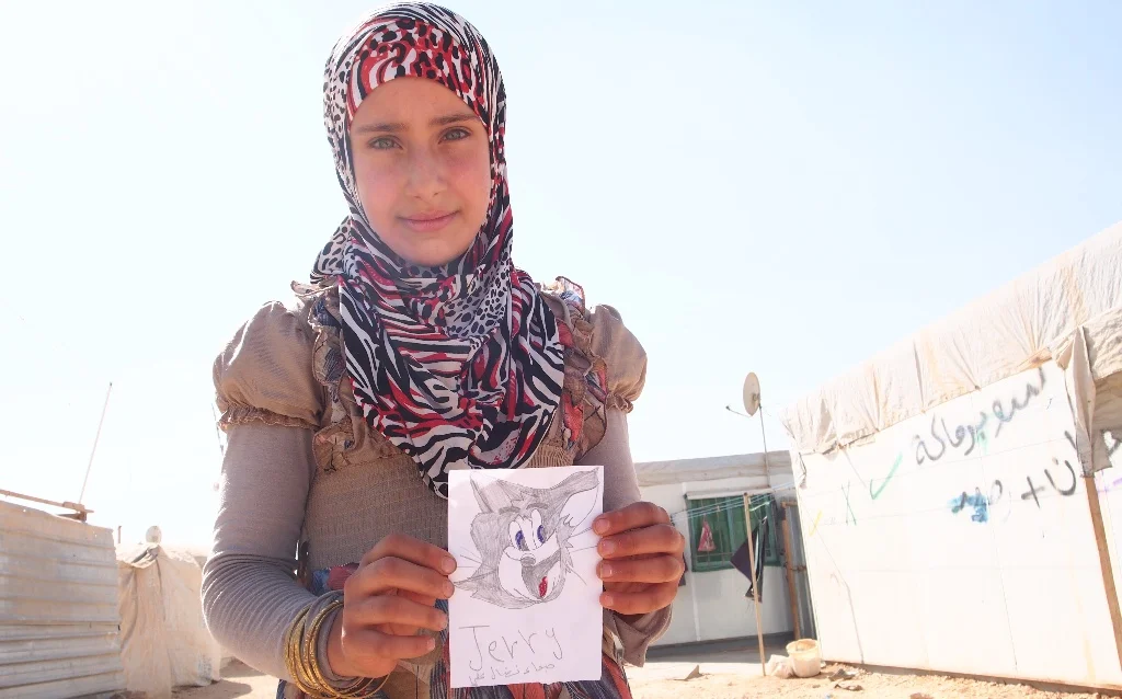 Youth at Zaatari Refugee Camp in Jordan share artwork with Director Grazyna Kolondra and team. See more of the children's work here.