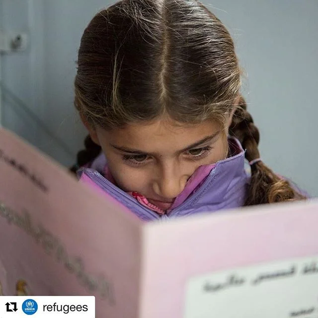 #images4change #Repost @refugees // Zeinab reads her favourite book, Snow White and the Seven Dwarfs, at the library at Filipadia camp on the Greek mainland. What is YOUR favorite book? 📚
.
The library in which Zeinab reads came to be because refuge